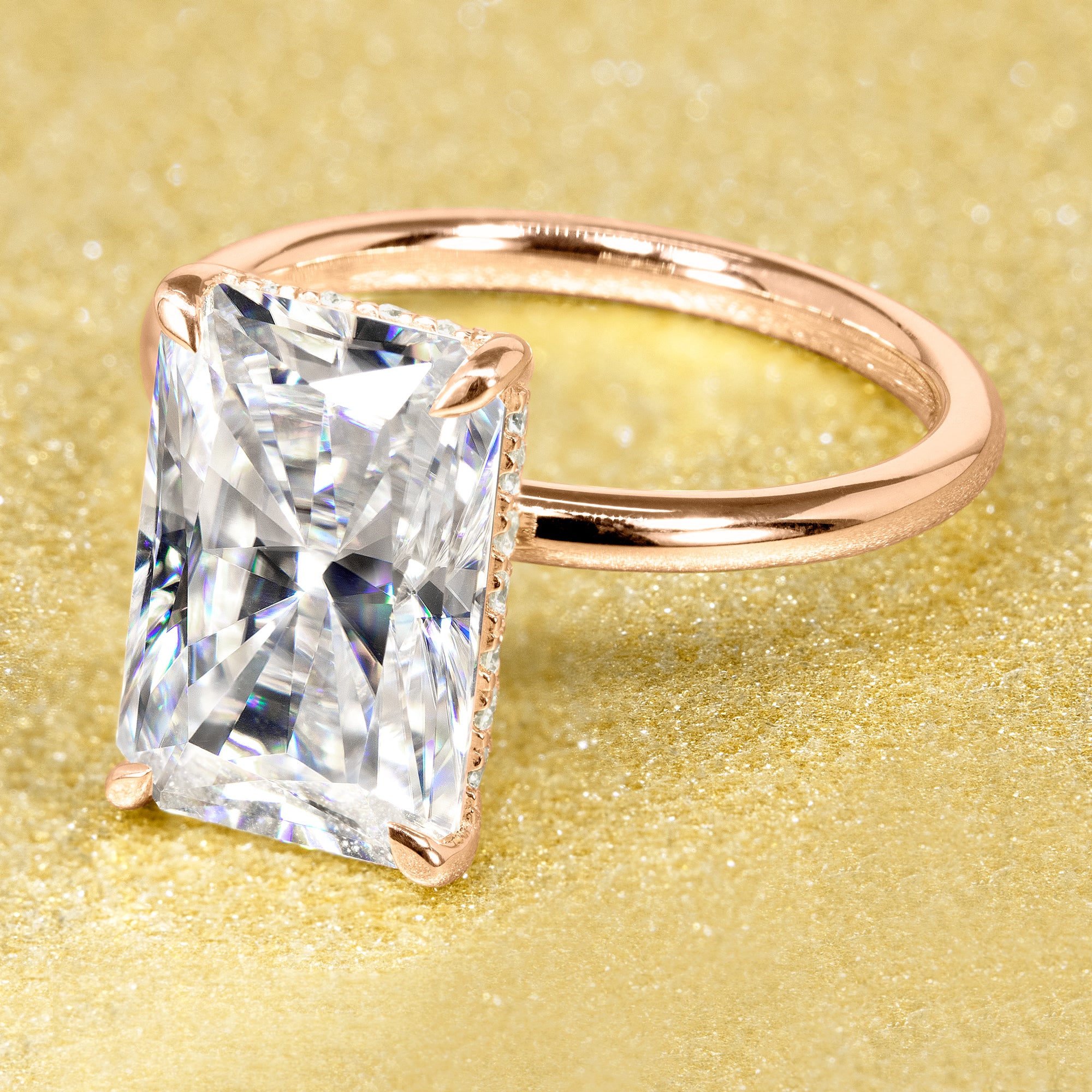 The Adara Elongated Radiant-cut Hidden Halo Moissanite Engagement Ring, a classic look with an elegant twist complemented by Lab Diamonds handcrafted in 14K gold, 18K gold, or Platinum handcrafted in Los Angeles by Earthena Jewelry.