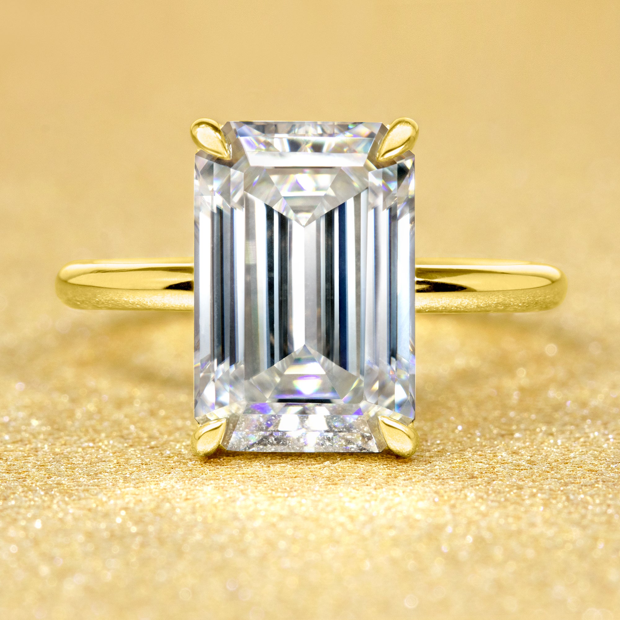 The Adara, 5ct Elongated Emerald-Cut Lab-Grown Diamond Hidden Halo Engagement Ring in 14K Gold, 18K Gold, or Platinum by Earthena Jewelry of Beverly Hills.
