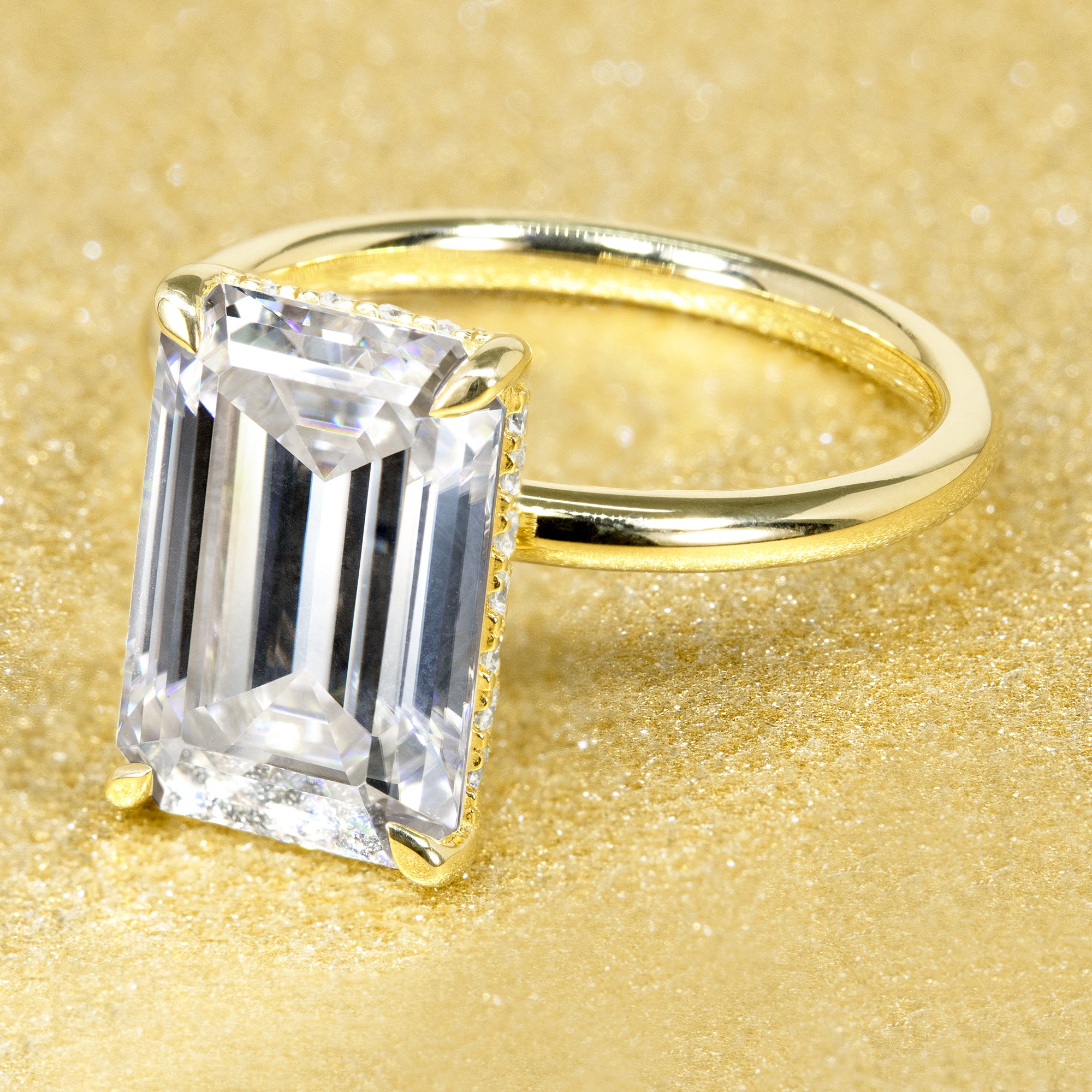 The Adara, 5ct Elongated Emerald-Cut Lab-Grown Diamond Hidden Halo Engagement Ring in 14K Gold, 18K Gold, or Platinum by Earthena Jewelry of Beverly Hills.