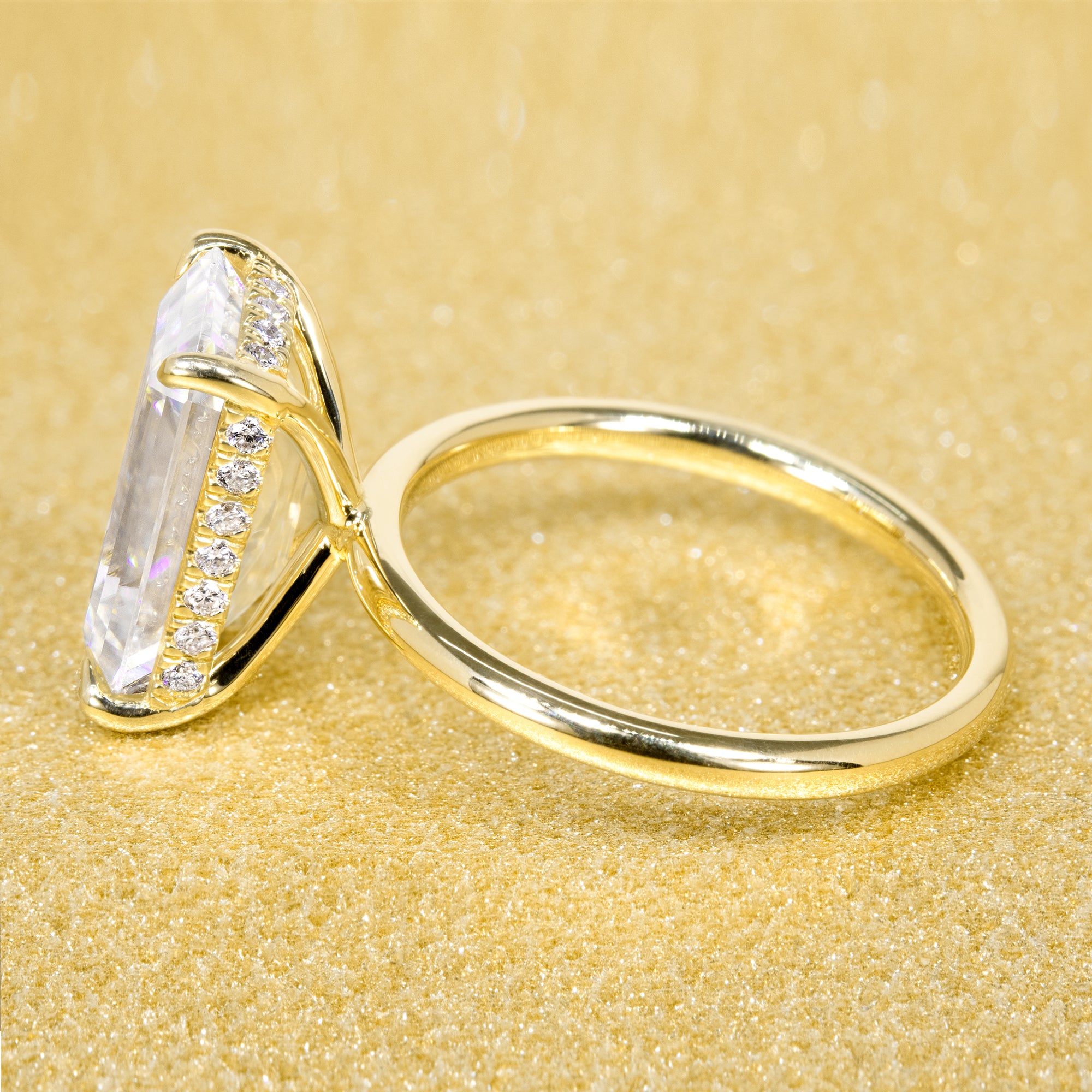 The Adara Elongated Emerald-cut Hidden Halo Moissanite Lab-grown Diamonds Engagement Ring handcrafted in 14K or 18K Gold handcrafted in Los Angeles by Earthena Jewelry.