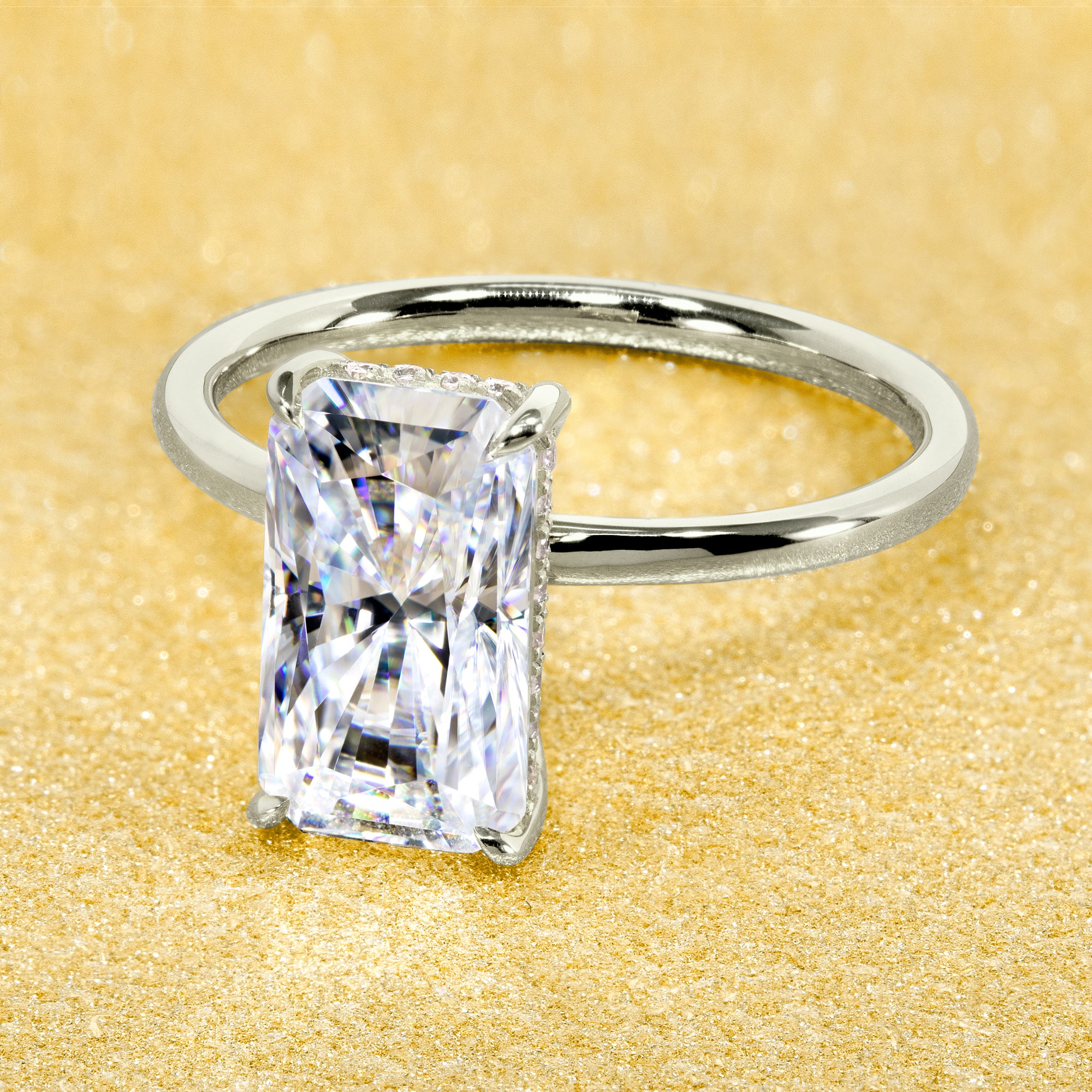 Classic Ariela 3ct Elongated Radiant-cut Moissanite Halo Solitaire Engagement ring complemented by Lab Diamonds handcrafted in 14K Gold, 18K Gold, or Platinum by Earthena Jewelry of Beverly Hills.