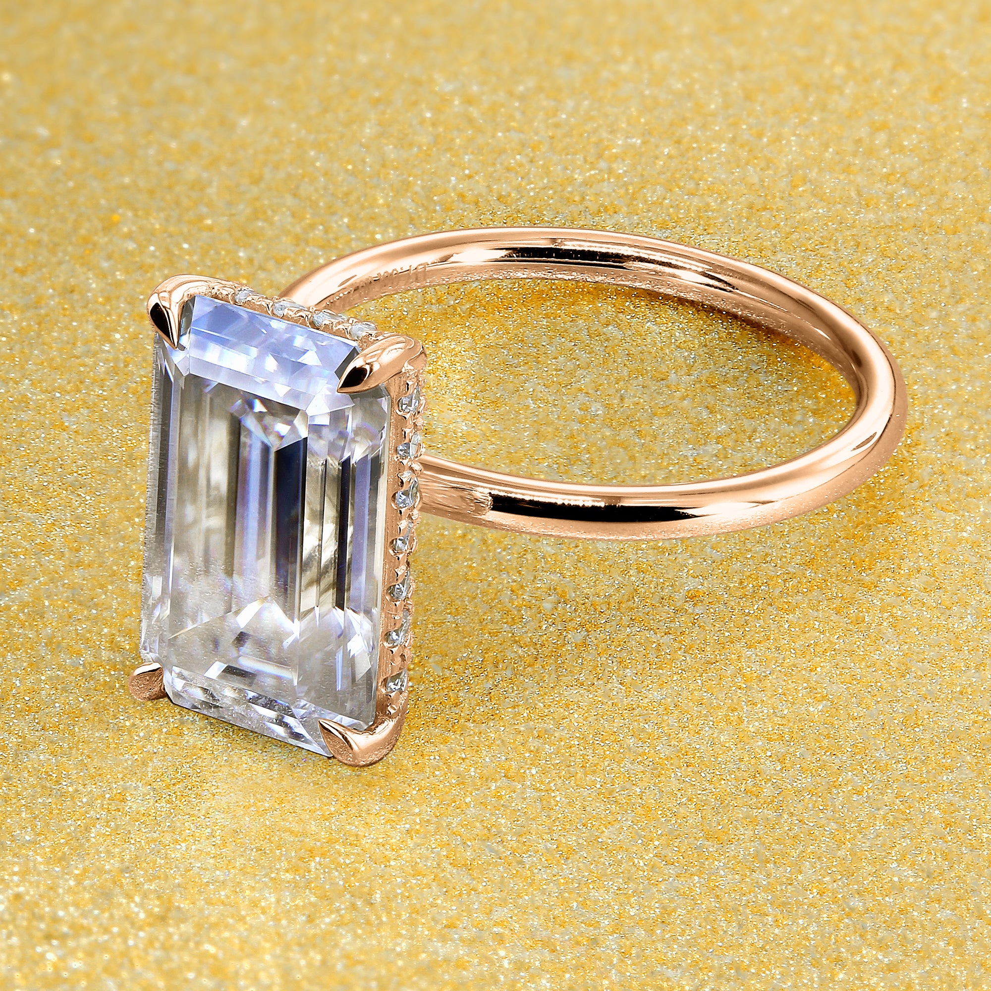 Classic Ariela 5.5ct Elongated Emerald-cut Moissanite Halo Solitaire Engagement ring complemented by Lab Diamonds handcrafted in 14K Gold, 18K Gold, or Platinum by Earthena Jewelry of Beverly Hills.