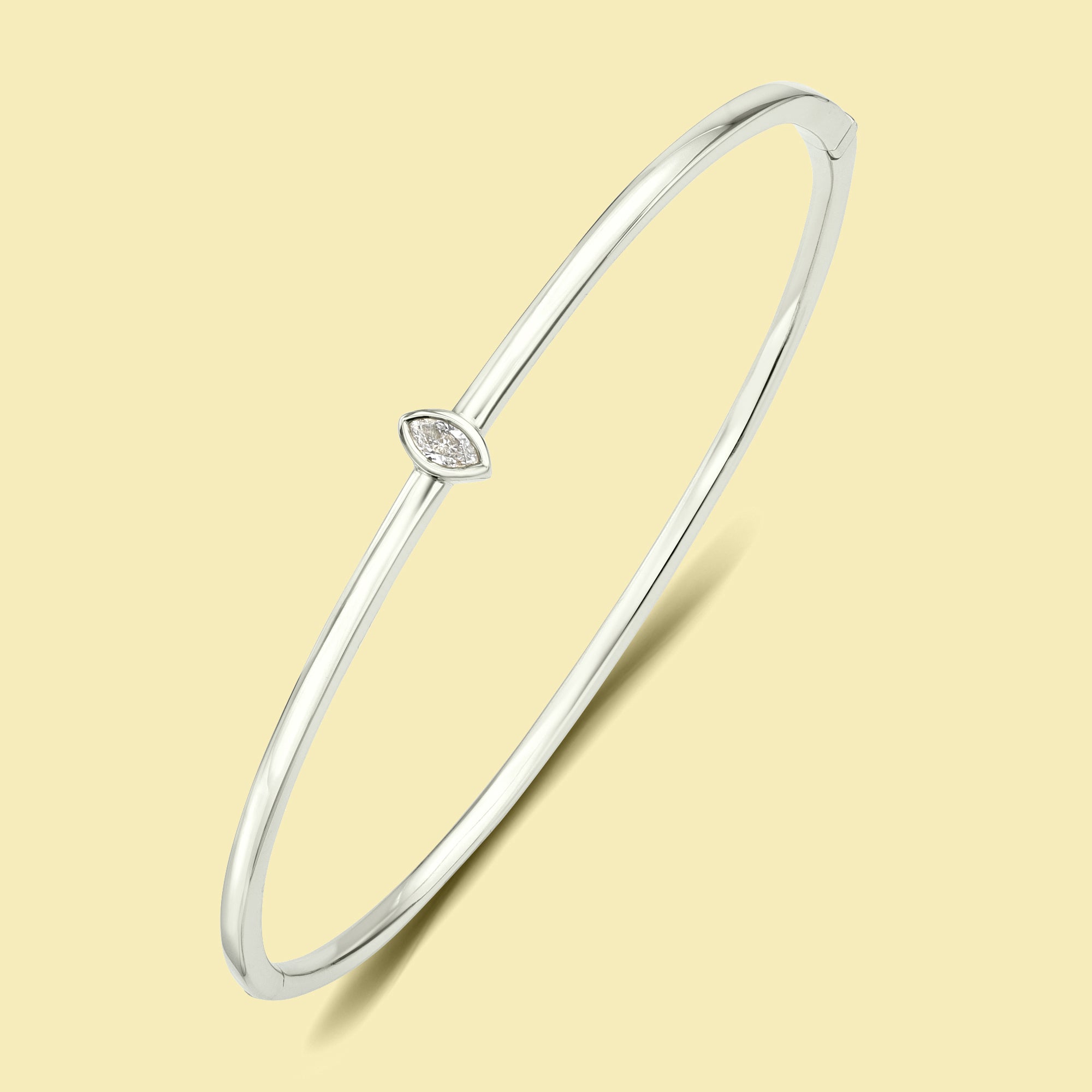 The Fiona, Marquise-cut Lab-grown and Natural diamond Bezel Solitaire Bangle handcrafted 14K gold, 18K gold and Platinum by Earthena Jewelry of Beverly Hills.