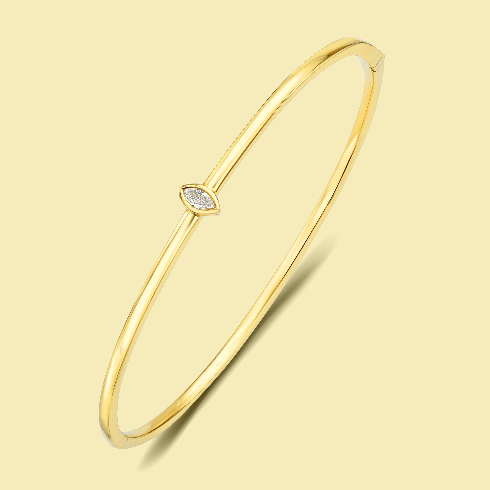 The Fiona, Marquise-cut Lab-grown and Natural diamond Bezel Solitaire Bangle handcrafted 14K gold, 18K gold and Platinum by Earthena Jewelry of Beverly Hills.