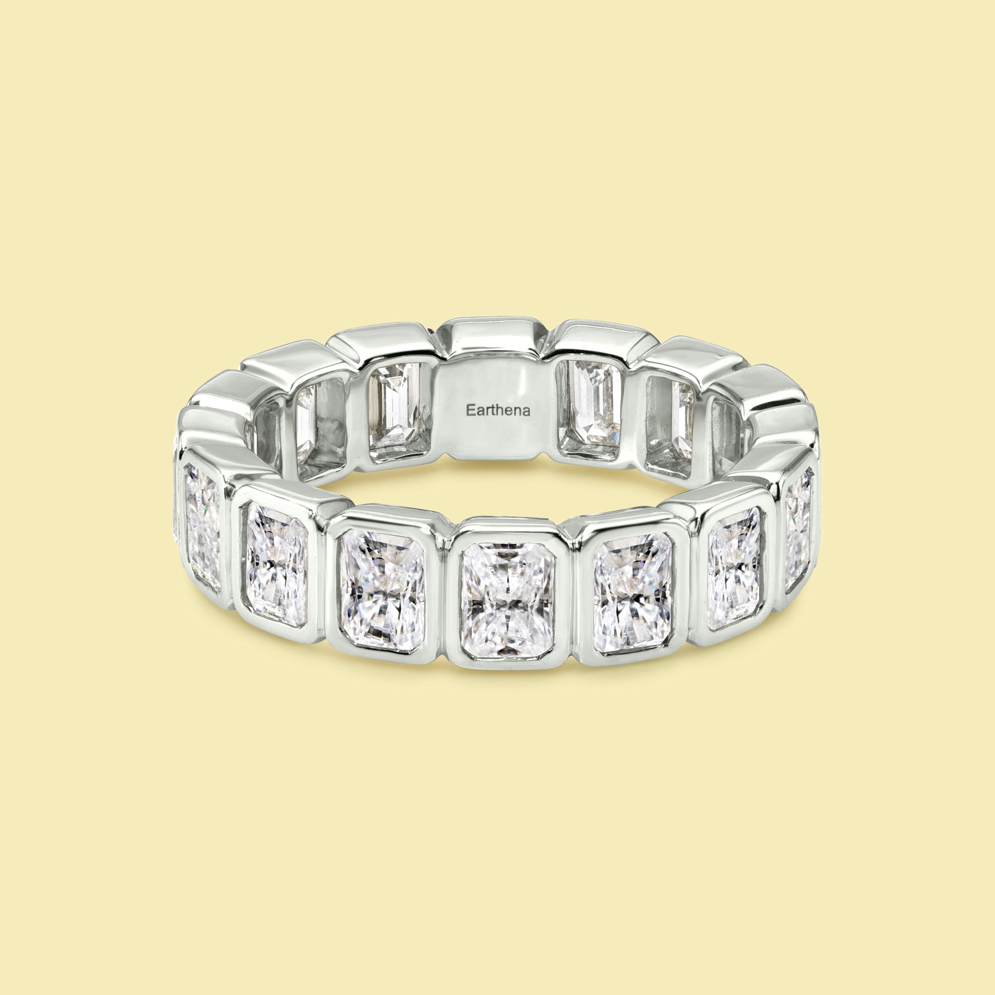 The Fiona Radiant-cut Diamond Bezel Eternity Band is handcrafted in 14K gold, 18K gold, and Platinum handcrafted in Los Angeles by Earthena Jewelry of Beverly Hills.