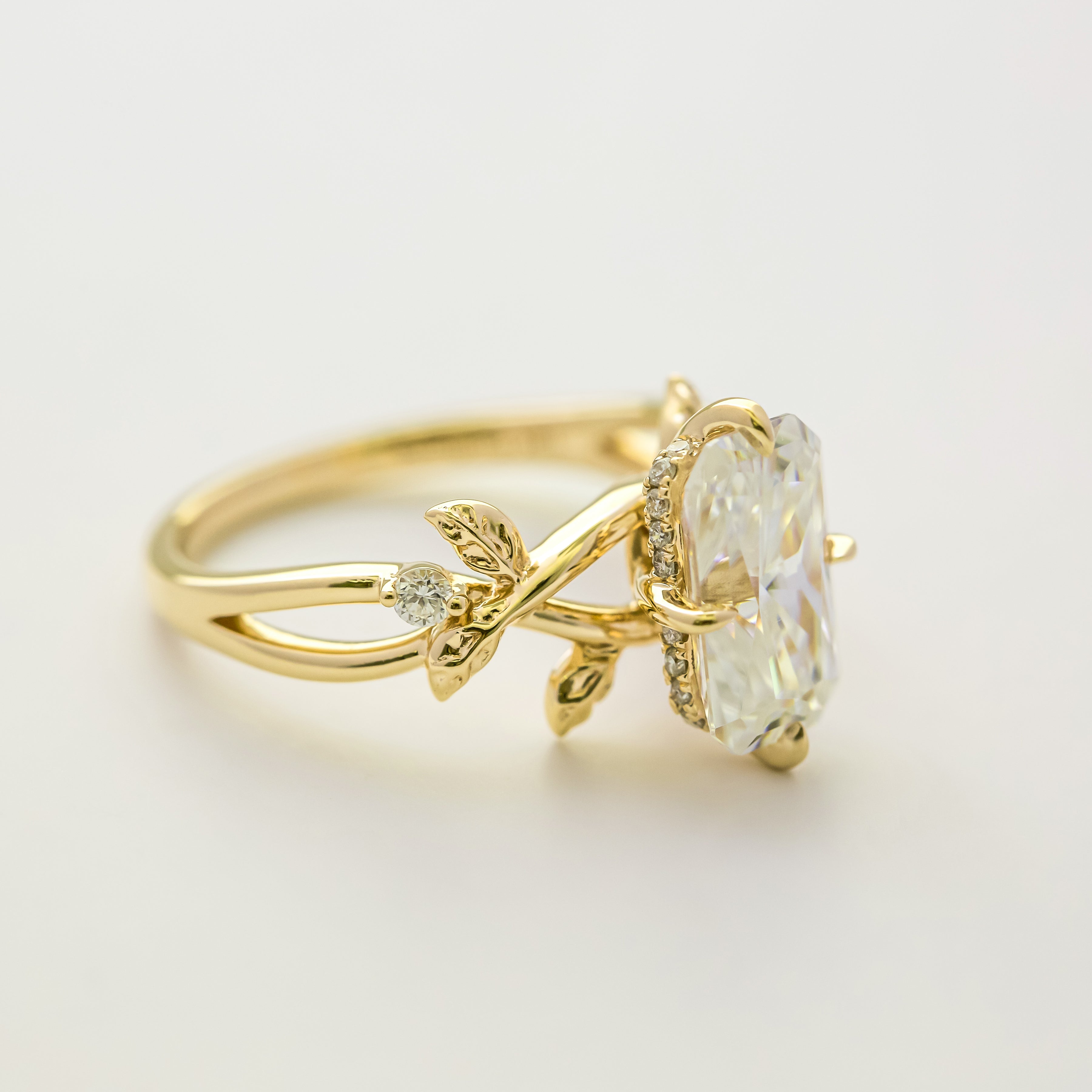 Flora 3ct Elongated Emerald-cut Moissanite Compass Hidden Halo Floral Lab-grown Diamond Engagement ring in 14K gold, 18K gold, or Platinum by Earthena Jewelry of Beverly Hills.