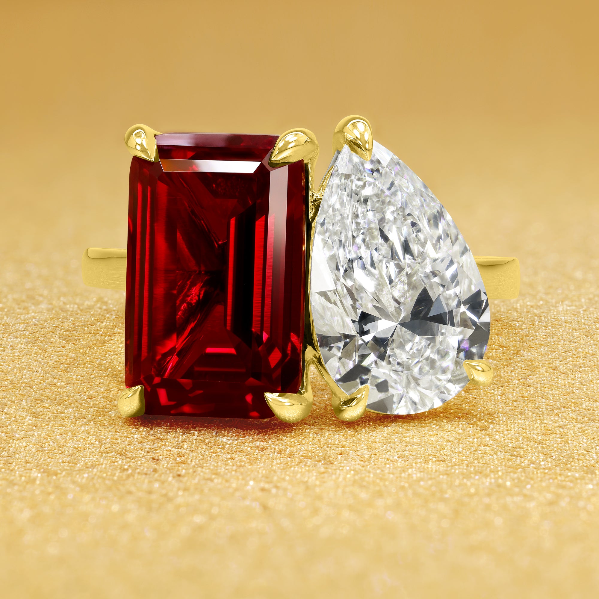 This timeless "Toi et Moi" Gemini Sleek cathedral engagement ring showcases a captivating combination of a 3.75ct lab-grown elongated emerald-cut ruby and a lab-grown 2ct pear-shaped diamond in a minimalistic plain gold band setting. The ring is available in 14K Gold, 18K Gold, or Platinum by Earthena Jewelry of Beverly Hills.