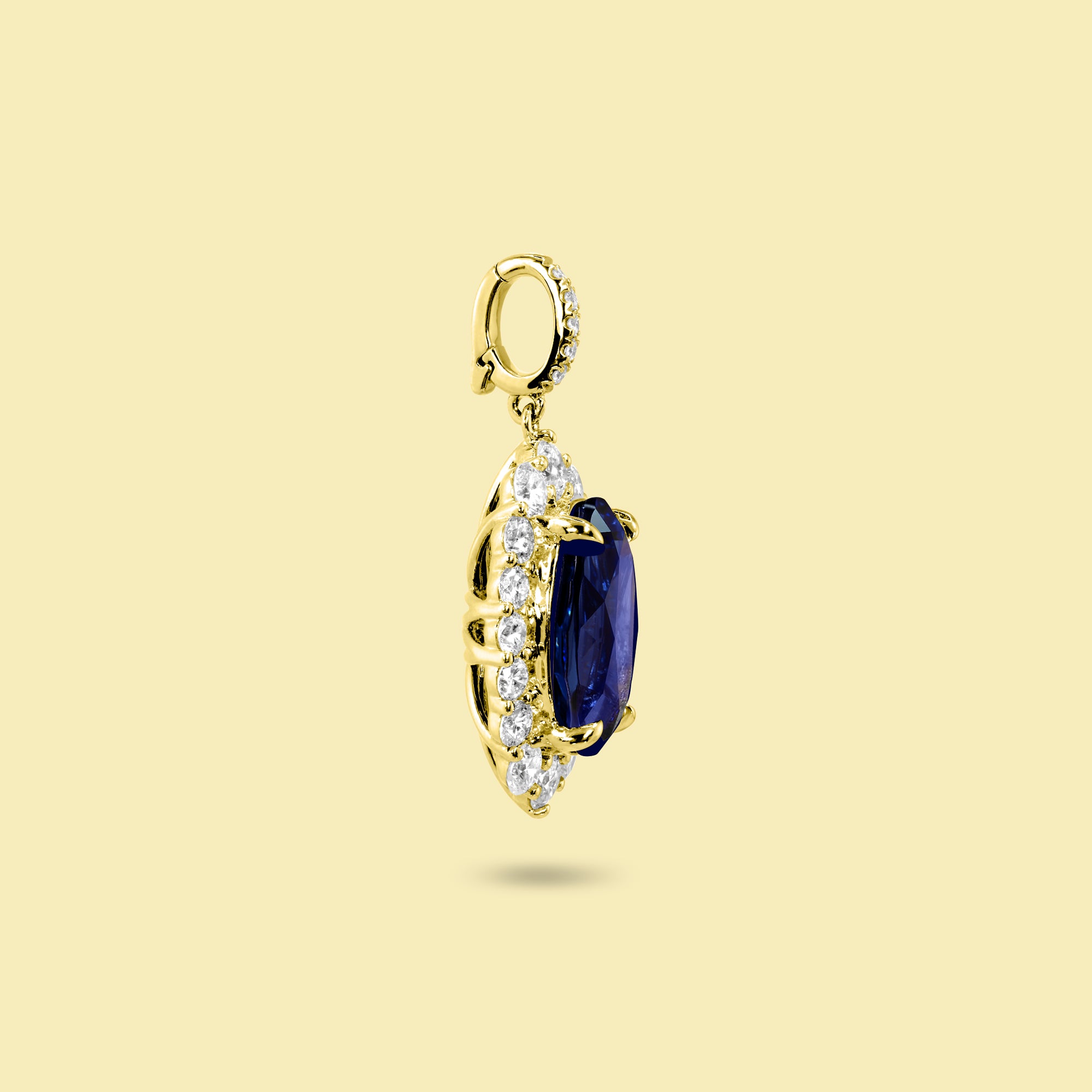 Gloria 4ct Elongated Lab-Grown Oval-Cut Blue Sapphire Halo Charm Pendant in 14K Gold, 18K Gold, or Platinum by Earthena Jewelry of Beverly Hills.