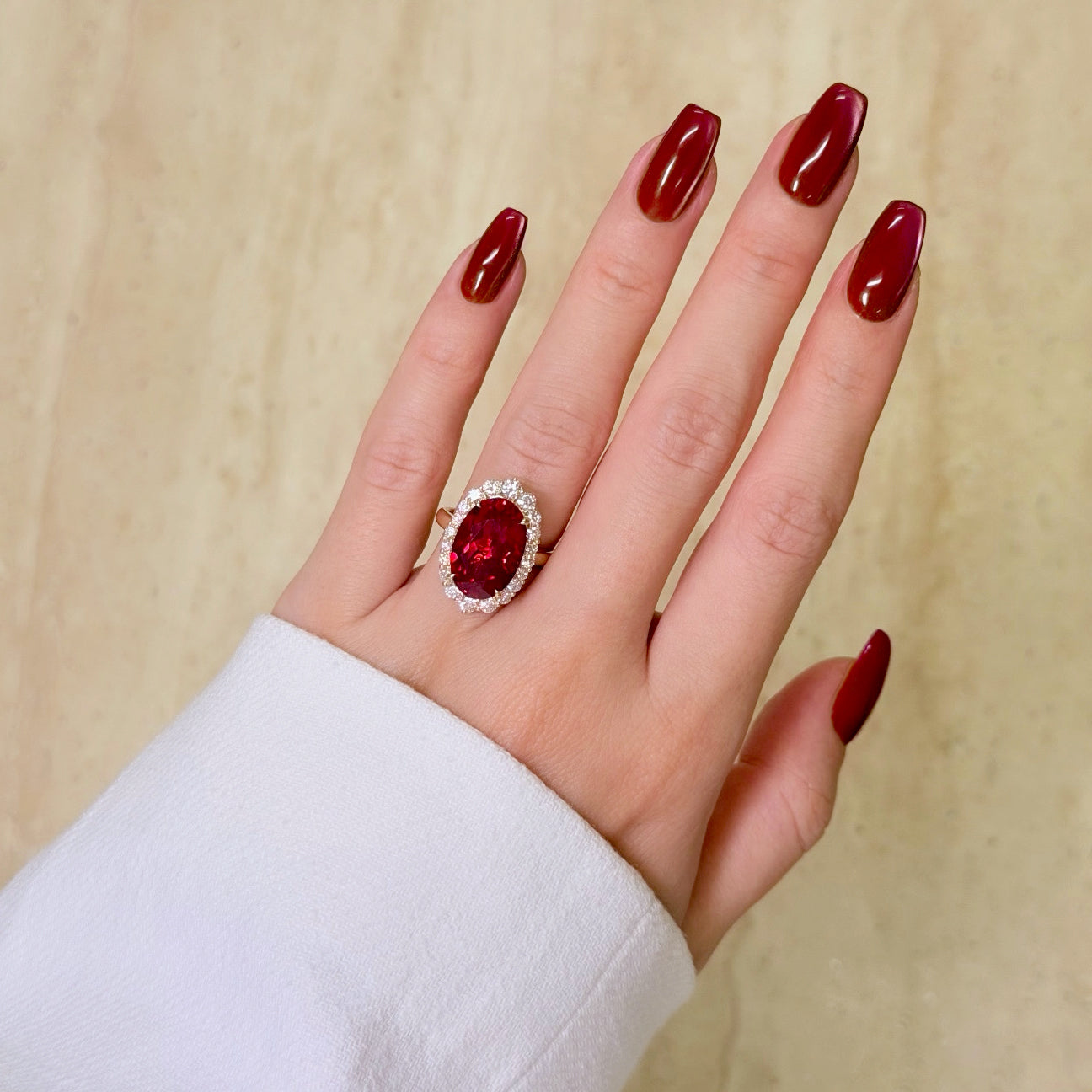 Gloria 8ct Elongated Lab-grown Oval-cut Ruby Halo Cathedral Engagement Ring in 14K Gold, 18K Gold, or Platinum by Earthena Jewelry of Beverly Hills.