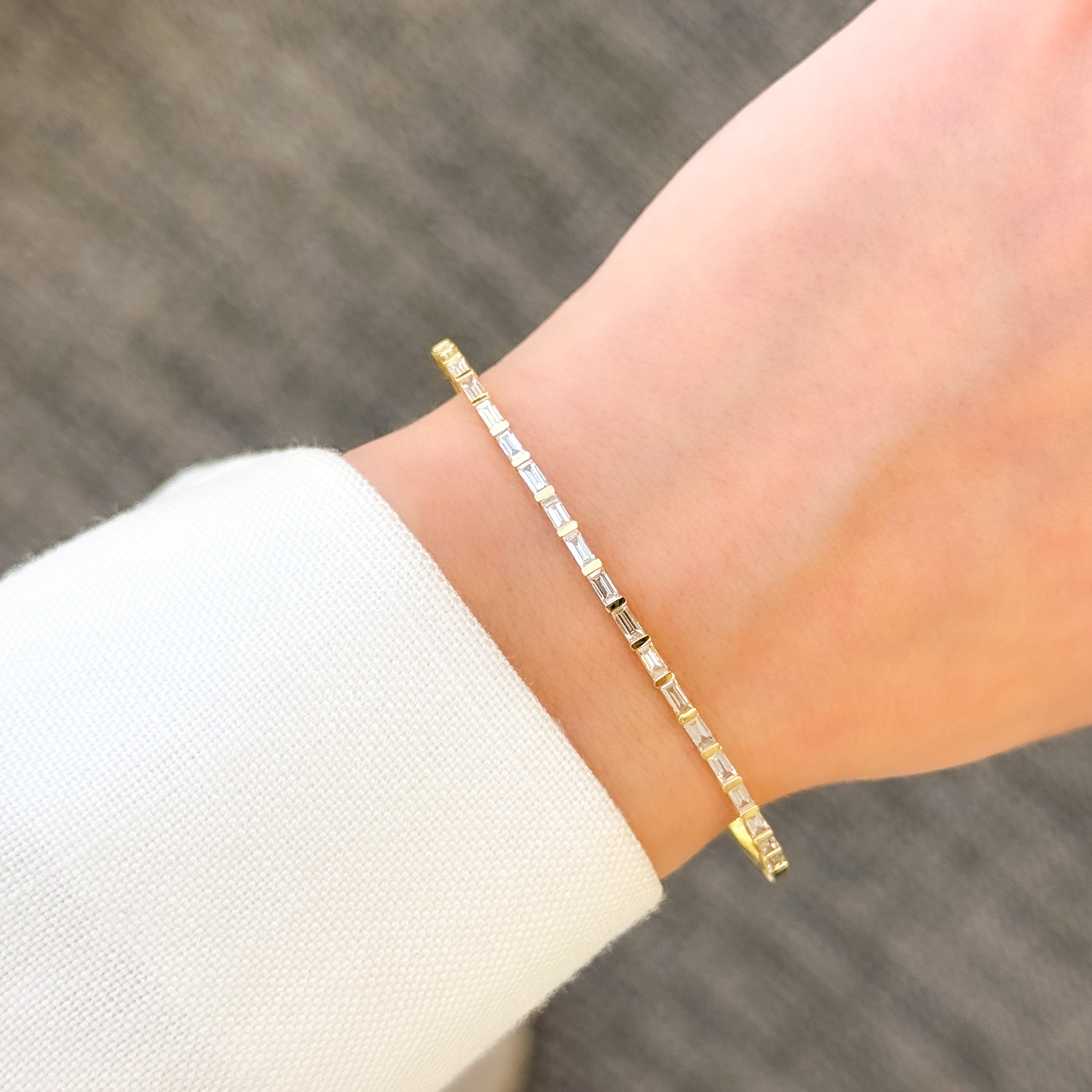 The Taylor, East-West Baguette Diamond Bangle is handcrafted in 14K gold, 18K gold, or Platinum handcrafted by Earthena Jewelry of Beverly Hills, California.