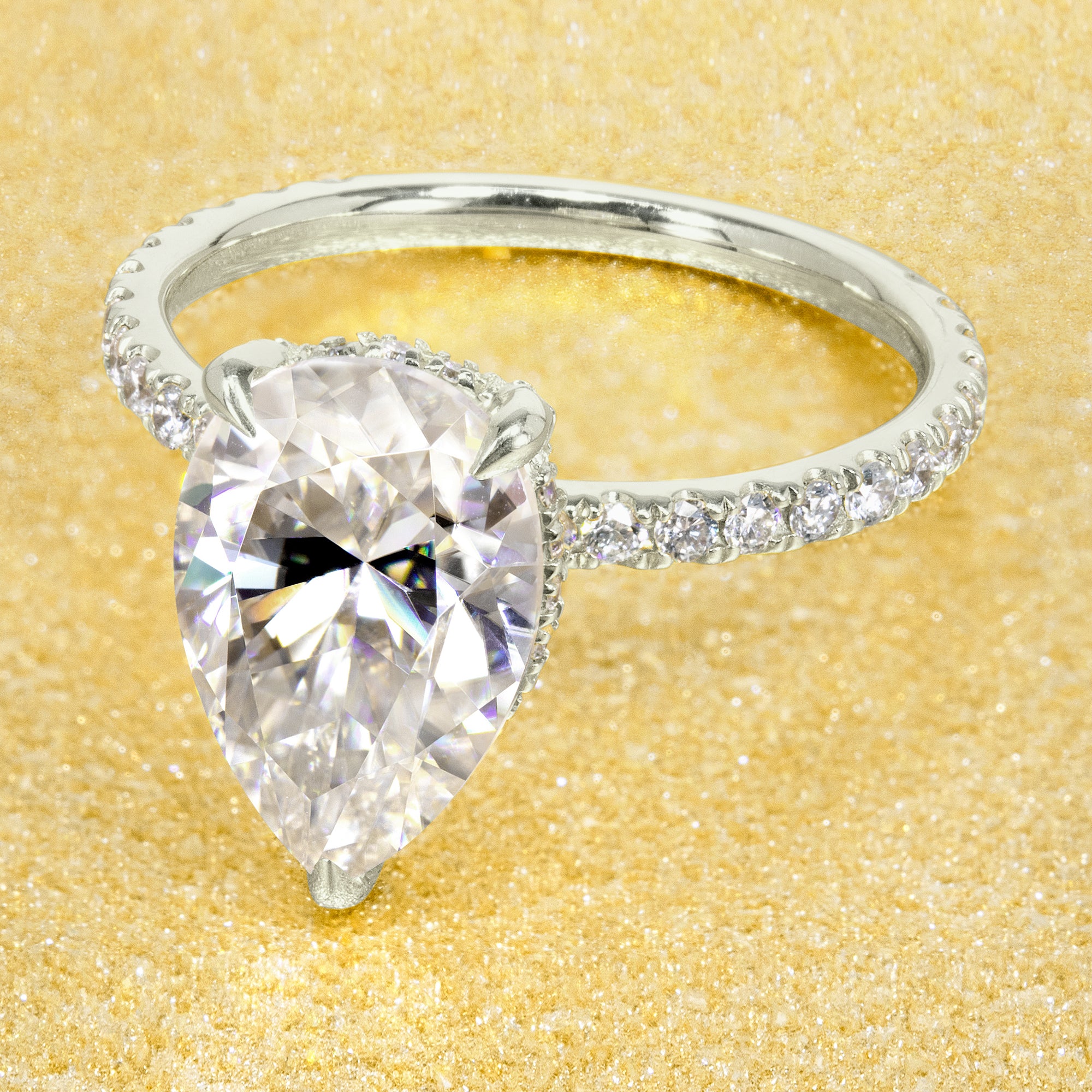 Classic and elegant 3.5-carat Elongated Pear-shaped Moissanite and Lab Diamond Hidden Wrap Halo engagement ring handcrafted in 14K gold, 18K gold, or Platinum Classic and elegant 3.5-carat Elongated Pear-shaped Moissanite and Lab Diamond Hidden Wrap Halo engagement ring handcrafted in 14K gold, 18K gold, or Platinum.