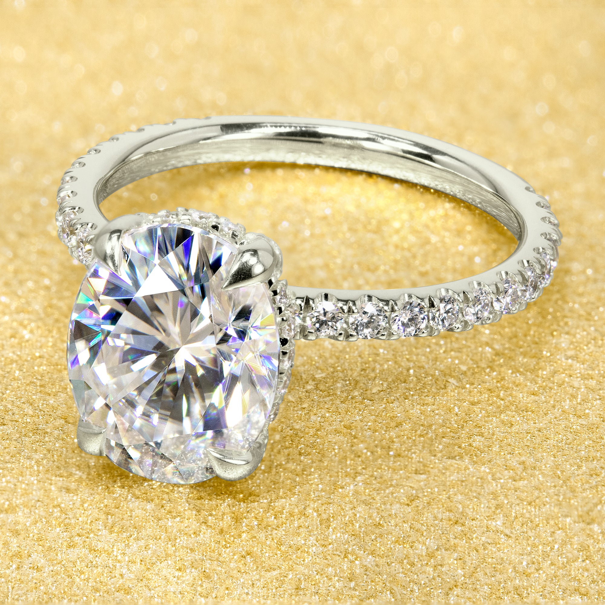 Classic and elegant 3-carats Oval-cut Moissanite and Lab Diamond Hidden Wrap Halo engagement ring handcrafted in 14K gold, 18K gold, or Platinum handcrafted in Los Angeles by Earthena Jewelry.
