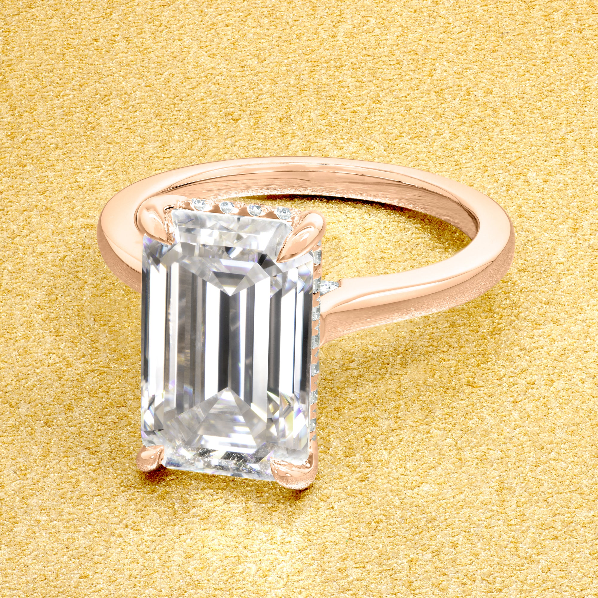 Classic Sofia 5ct Elongated Emerald-cut Moissanite Cathedral Hidden Halo Diamond Bridge Solitaire Engagement Ring in 14K Gold, 18K Gold, or Platinum by Earthena Jewelry of Beverly Hills.