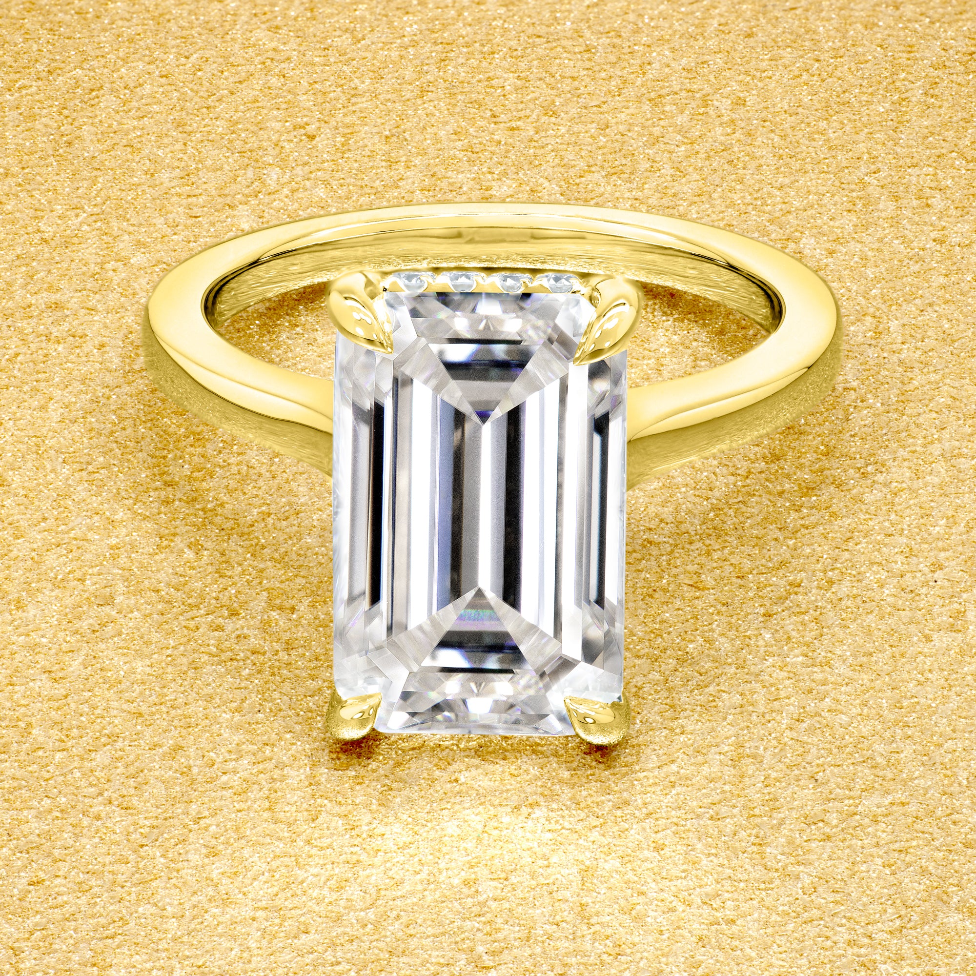 Classic Sofia 5ct Elongated Emerald-cut Moissanite Cathedral Hidden Halo Diamond Bridge Solitaire Engagement Ring in 14K Gold, 18K Gold, or Platinum by Earthena Jewelry of Beverly Hills.