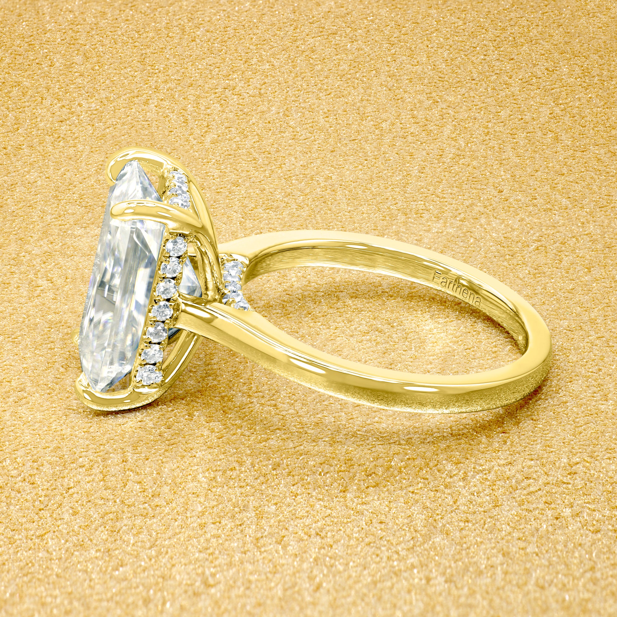 Classic Sofia 5ct Elongated Emerald-cut Moissanite Cathedral Hidden Halo Diamond Bridge Solitaire Engagement Ring in 14K Gold, 18K Gold, or Platinum by Earthena Jewelry of Beverly Hills.
