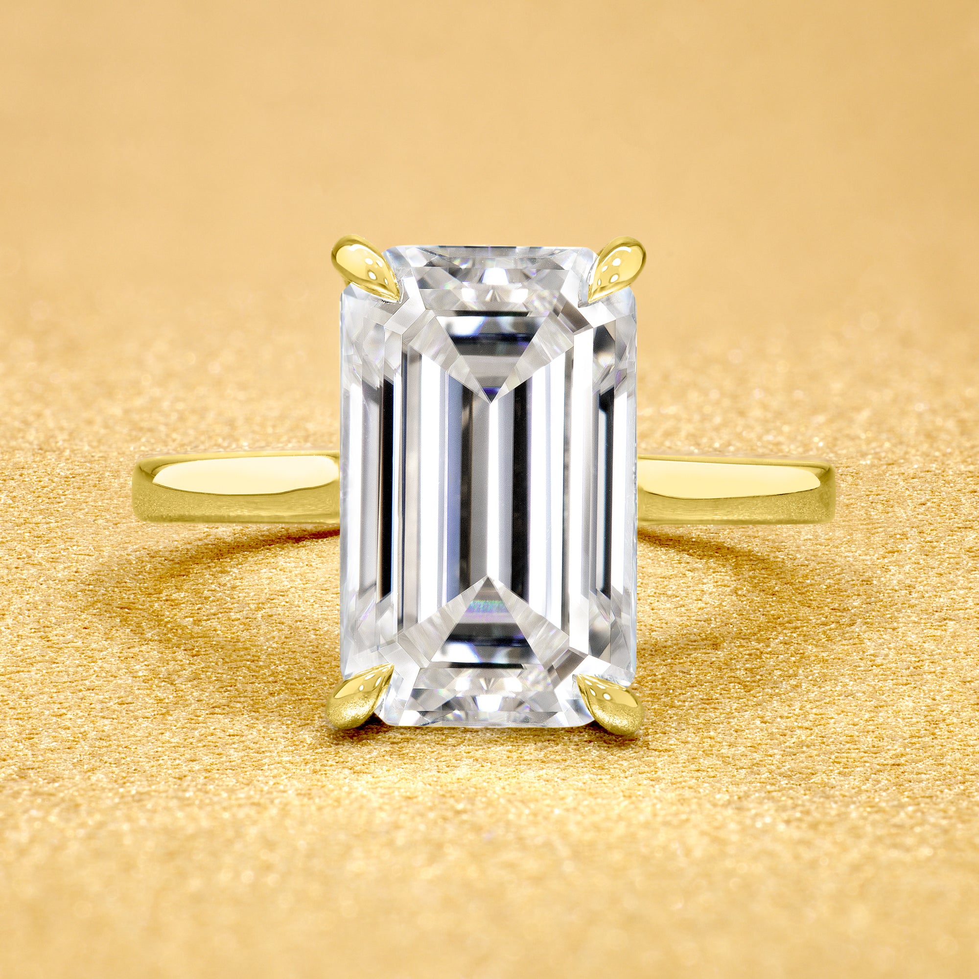 Classic Sofia 5ct Elongated Emerald-cut Moissanite Cathedral Hidden Halo Diamond Bridge Solitaire Engagement Ring in 14K Gold, 18K Gold, or Platinum by Earthena Jewelry of Beverly Hills.