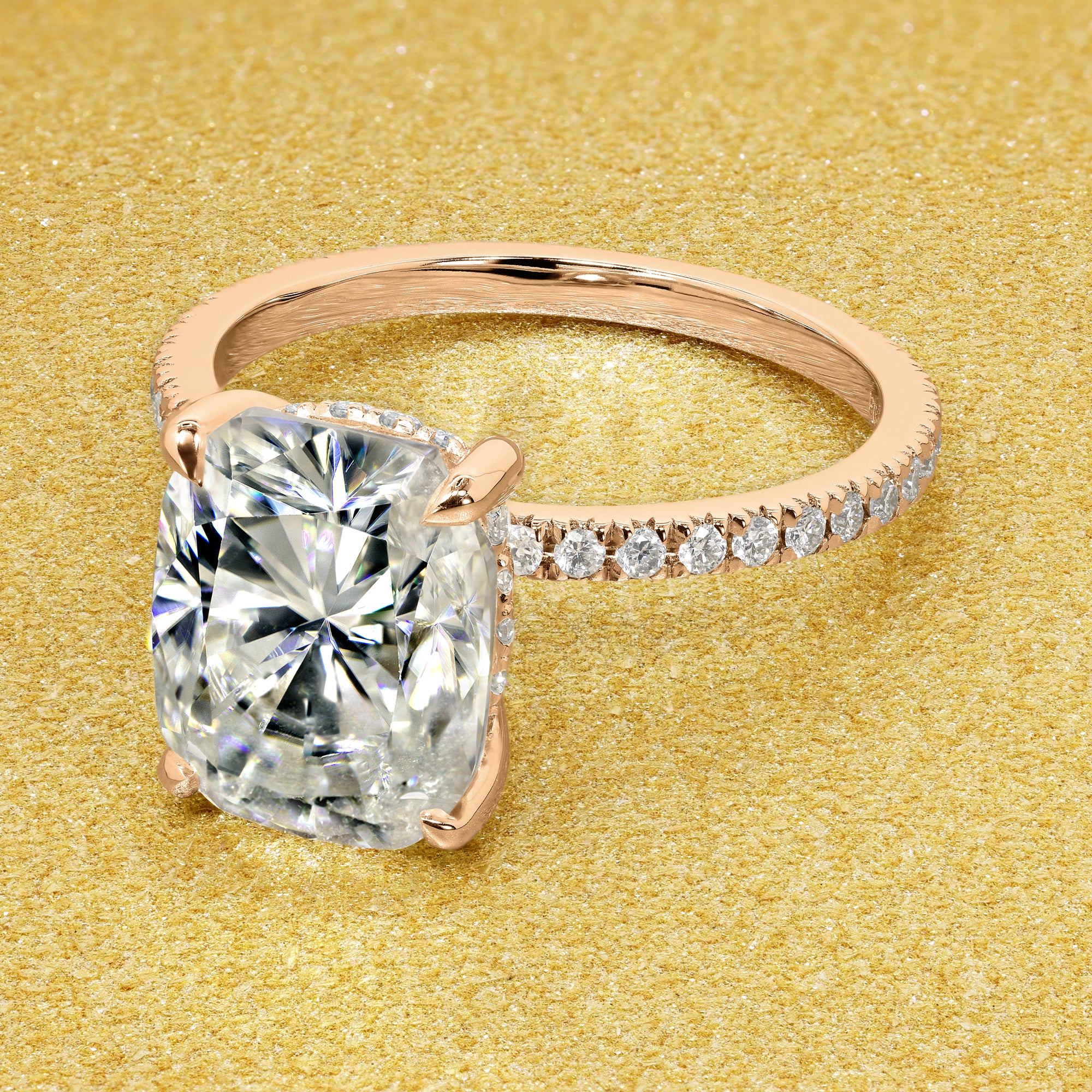 The Stella Elongated Brilliant-cut Cushion-cut Pave band Hidden Halo Moissanite Engagement Ring is a classic look with an elegant twist complemented by Moissanite stones handcrafted in 14K Gold, 18K Gold, or Platinum handcrafted in Los Angeles by Earthena Jewelry.
