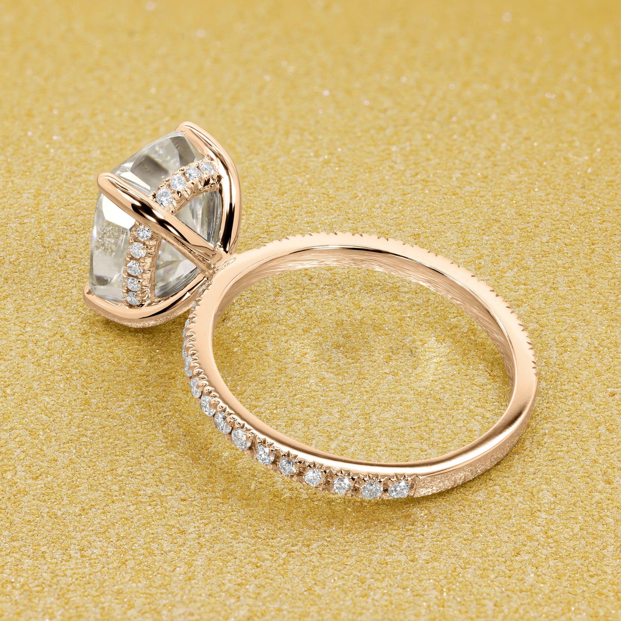 The Stella Elongated Brilliant-cut Cushion-cut Pave band Hidden Halo Moissanite Engagement Ring is a classic look with an elegant twist complemented by Moissanite stones handcrafted in 14K Gold, 18K Gold, or Platinum handcrafted in Los Angeles by Earthena Jewelry.
