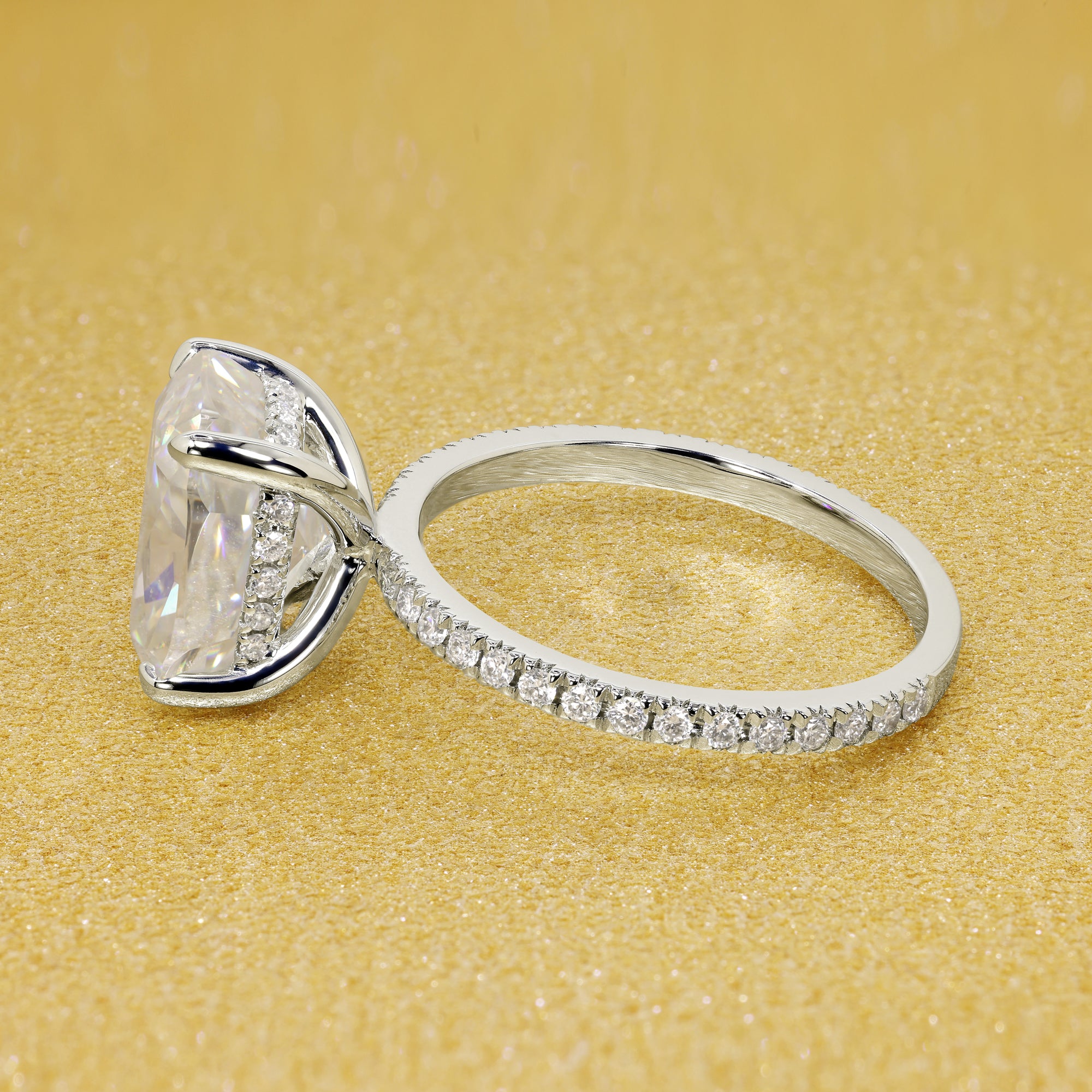 The Stella Elongated Brilliant-cut Cushion-cut Pave band Hidden Halo Moissanite Engagement Ring is a classic look with an elegant twist complemented by Moissanite stones handcrafted in 14K Gold, 18K Gold, or Platinum handcrafted in Los Angeles by Earthena Jewelry.