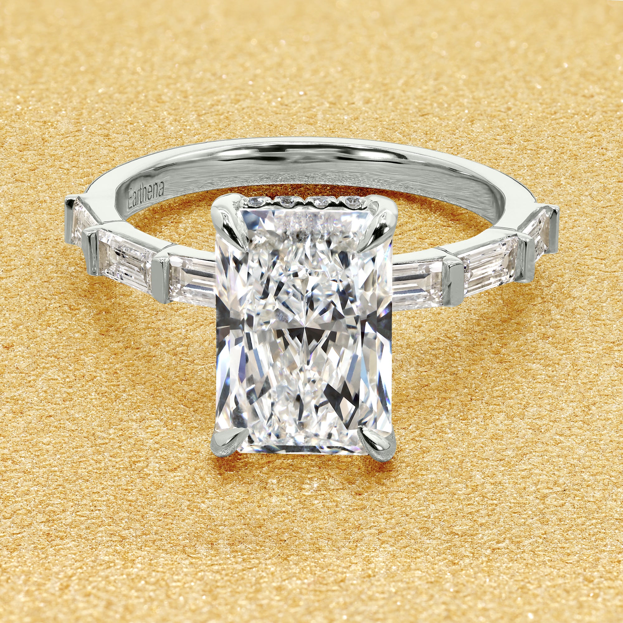 The Taylor, 3ct Elongated Radiant-Cut Lab-Grown Diamond Hidden Halo Baguette Engagement Ring in 14K Gold, 18K Gold, or Platinum by Earthena Jewelry of Beverly Hills.