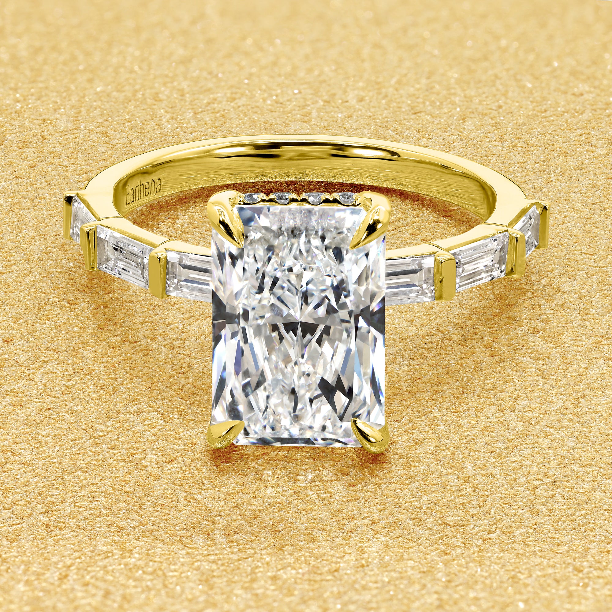 The Taylor, 3ct Elongated Radiant-Cut Lab-Grown Diamond Hidden Halo Baguette Engagement Ring in 14K Gold, 18K Gold, or Platinum by Earthena Jewelry of Beverly Hills.