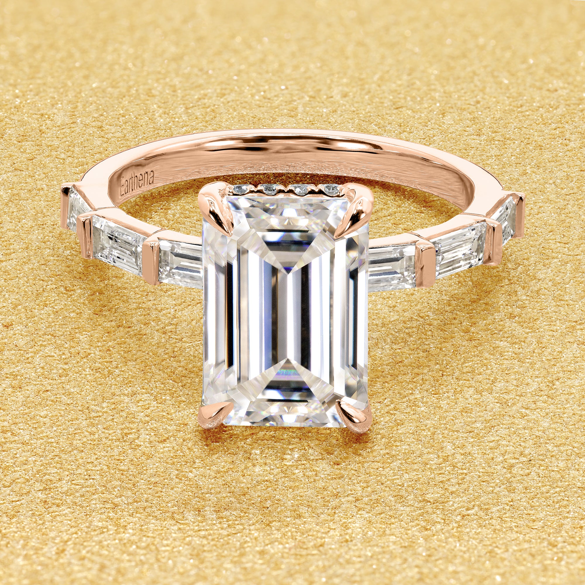 The Taylor, 3ct Elongated Emerald-Cut Lab-Grown Diamond Hidden Halo Baguette Engagement Ring in 14K Gold, 18K Gold, or Platinum by Earthena Jewelry of Beverly Hills.
