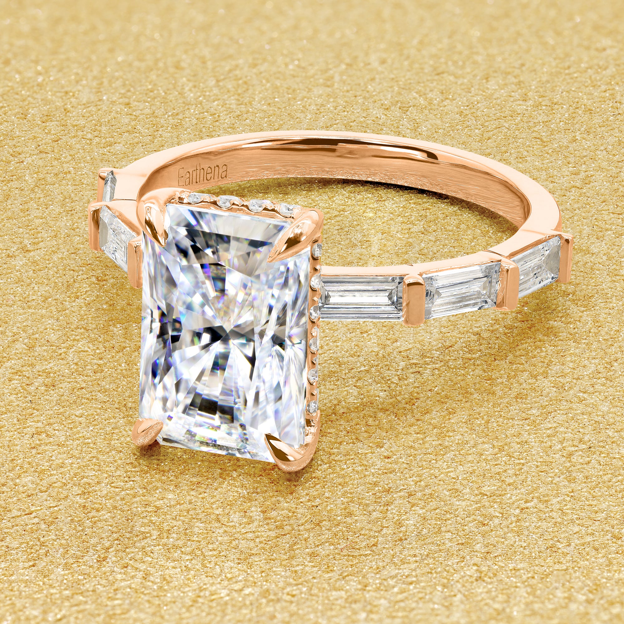 The Taylor 3ct elongated radiant-cut moissanite stone with lab-grown diamond accents set in 14K gold, 18K gold, or Platinum by Earthena Jewelry of Beverly Hills.