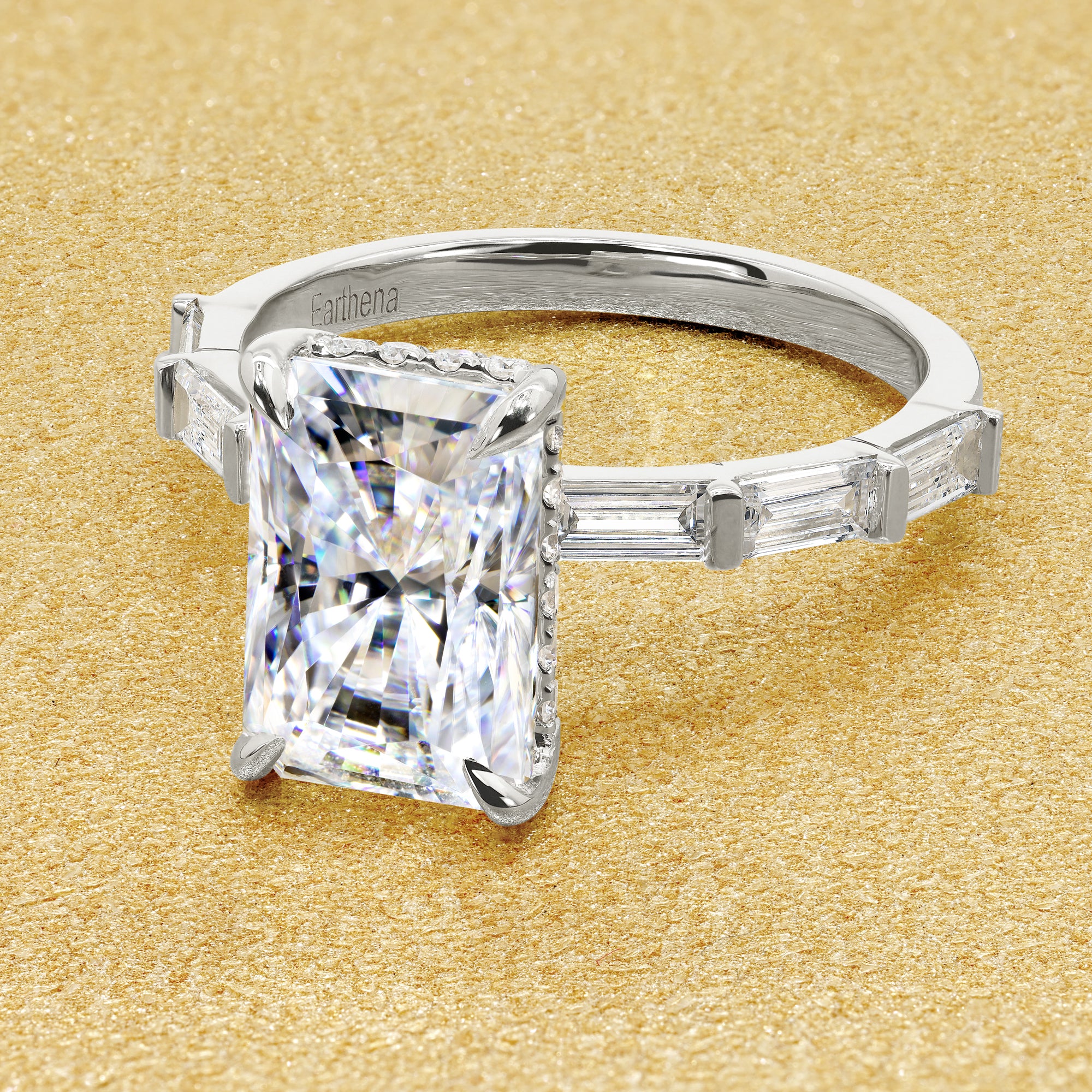 The Taylor 3ct elongated radiant-cut moissanite stone with lab-grown diamond accents set in 14K gold, 18K gold, or Platinum by Earthena Jewelry of Beverly Hills.