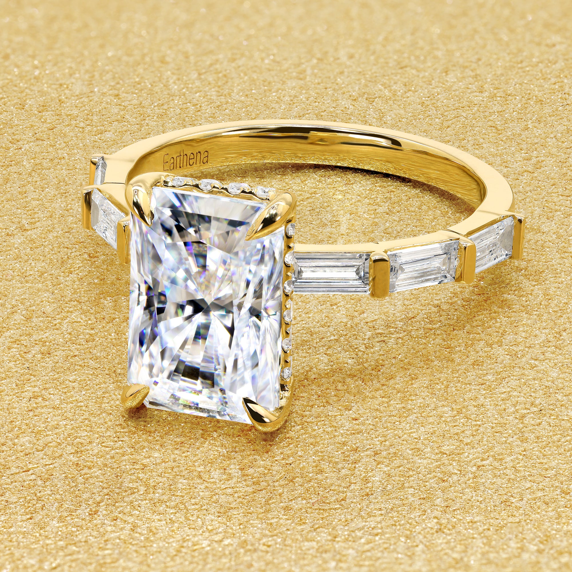 The Taylor 3ct elongated radiant-cut moissanite stone with lab-grown diamond accents set in 14K gold, 18K gold, or Platinum by Earthena Jewelry of Beverly Hills.
