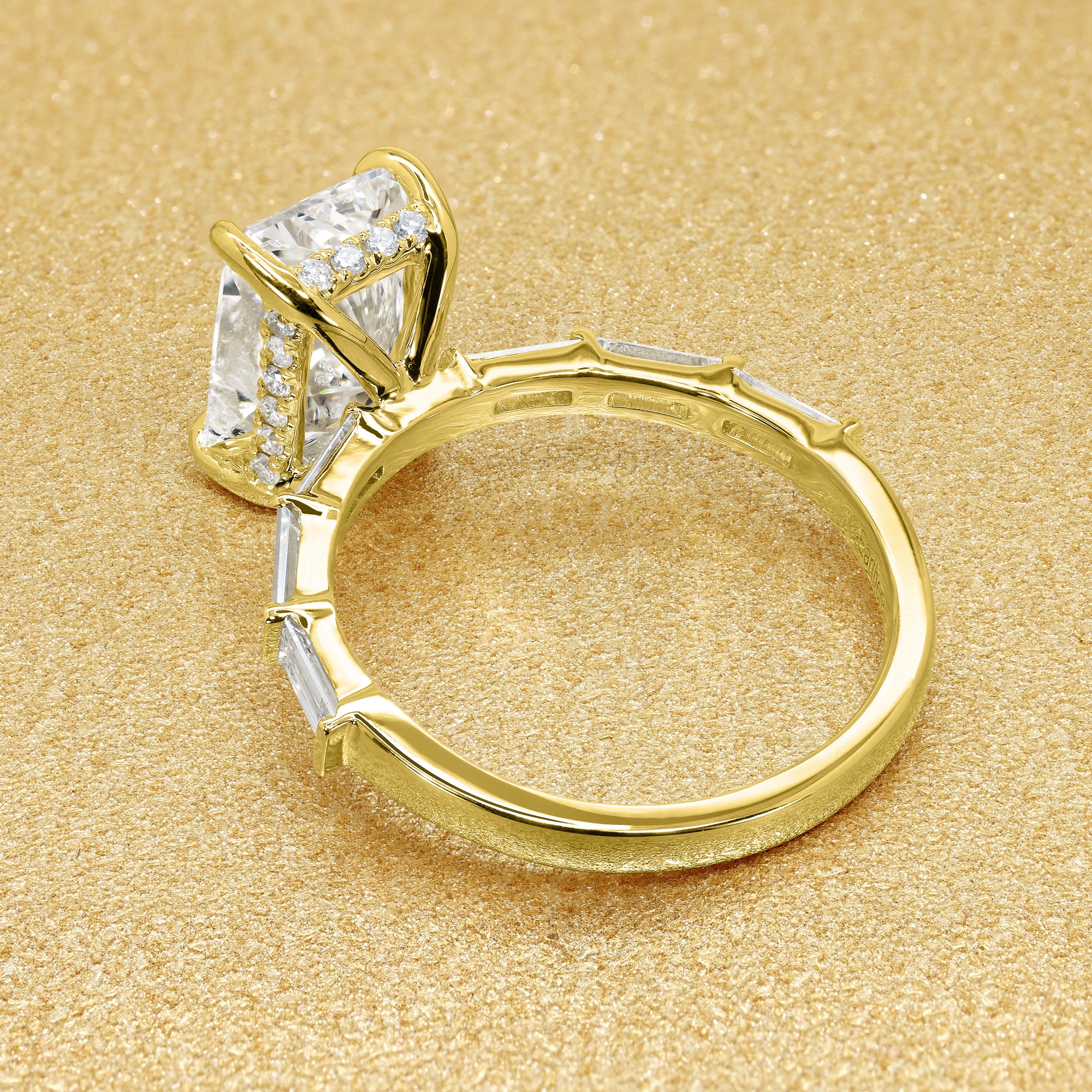 The Taylor 3ct elongated radiant-cut moissanite stone with lab-grown diamond accents set in 14K gold, 18K gold, or Platinum by Earthena Jewelry of Beverly Hills.