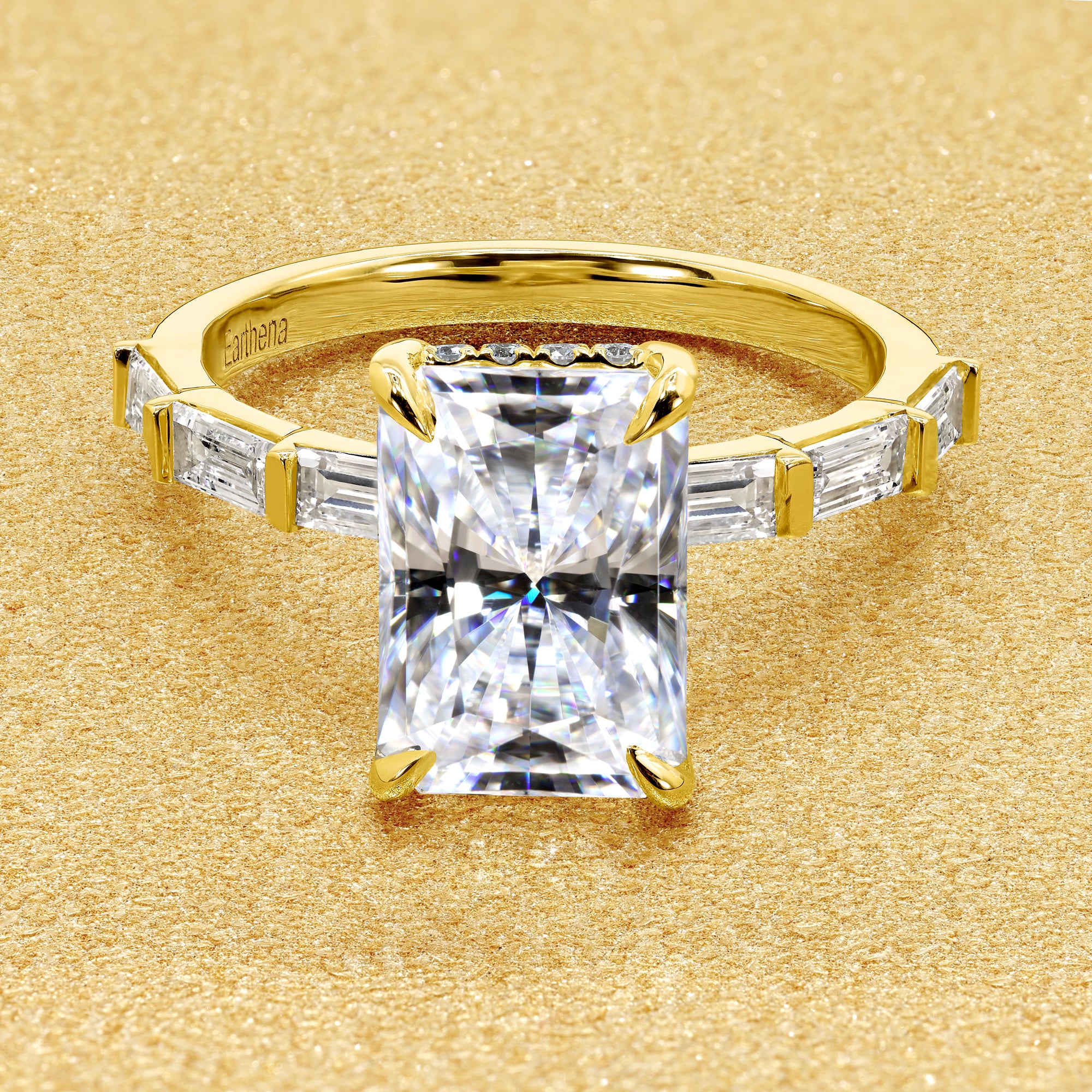 The Taylor 3ct elongated radiant-cut moissanite stone with lab-grown diamond accents set in 14K gold, 18K gold, or Platinum by Earthena Jewelry of Beverly Hills.