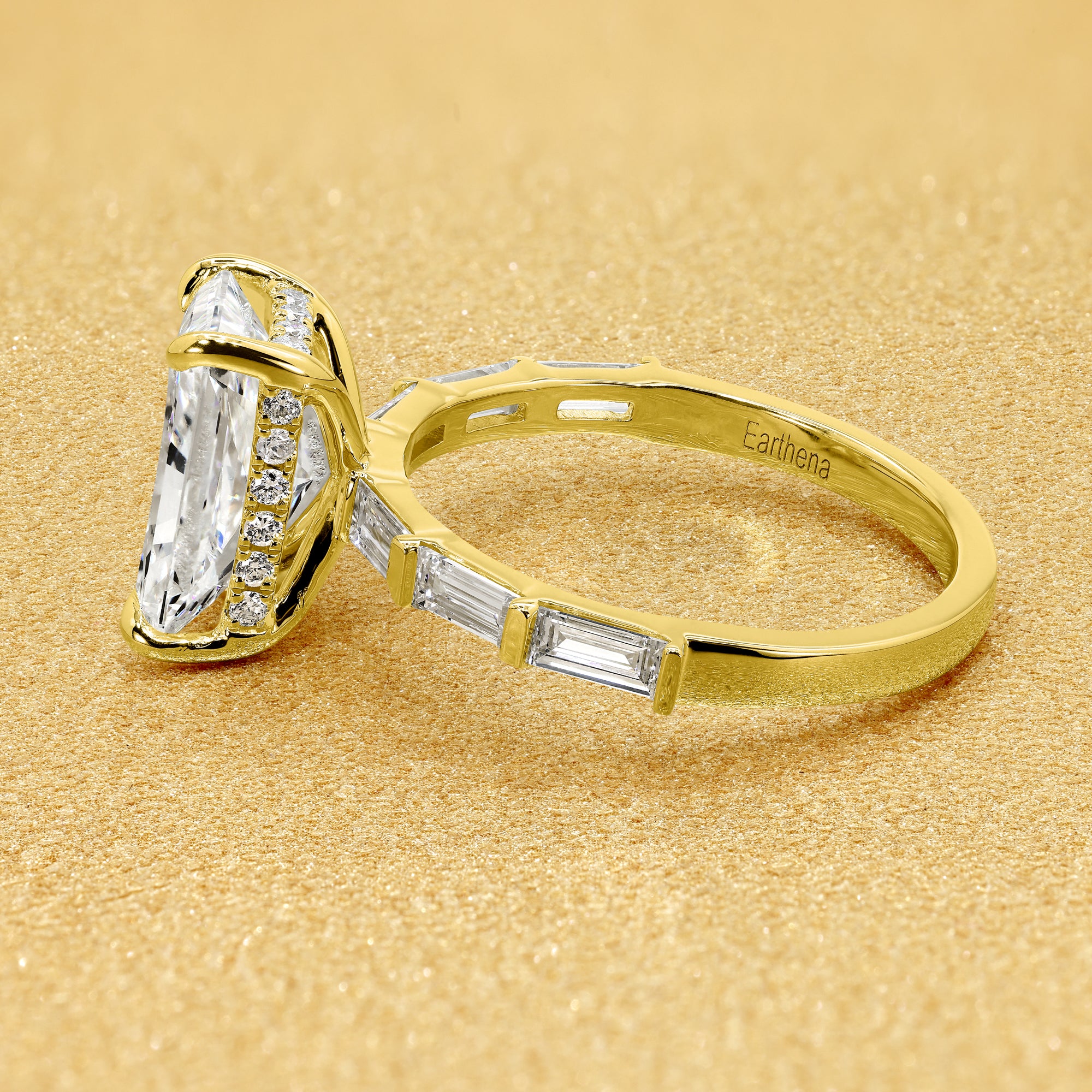 The Taylor 3ct elongated radiant-cut moissanite stone with lab-grown diamond accents set in 14K gold, 18K gold, or Platinum by Earthena Jewelry of Beverly Hills.