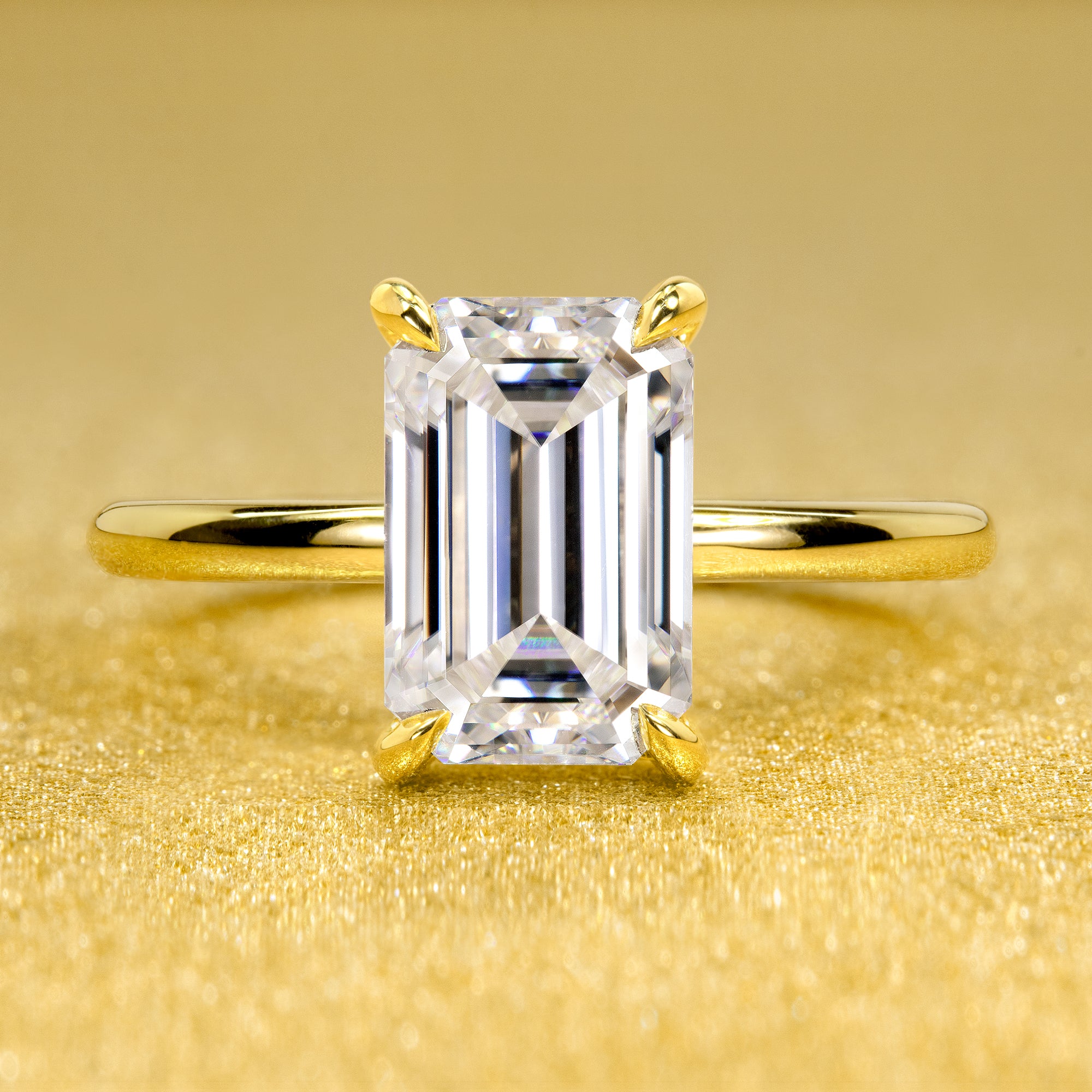 The Adara Elongated 3ct Emerald-cut Moissanite Hidden Halo Engagement Ring is a classic look with an elegant twist complemented by Lab Diamonds handcrafted in 14K Gold, 18K Gold, or Platinum by Earthena Jewelry of Beverly Hills.