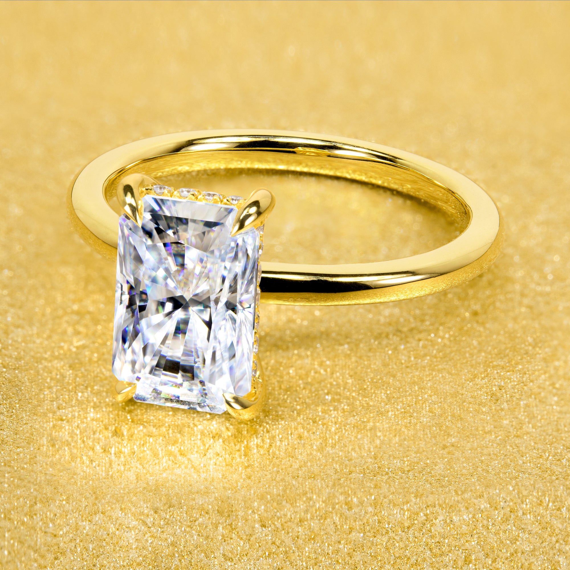 The Adara Elongated 3ct Radiant-cut Moissanite Hidden Halo Engagement Ring is a classic look with an elegant twist complemented by Lab Diamonds handcrafted in 14K Gold, 18K Gold, or Platinum by Earthena Jewelry of Beverly HIlls.