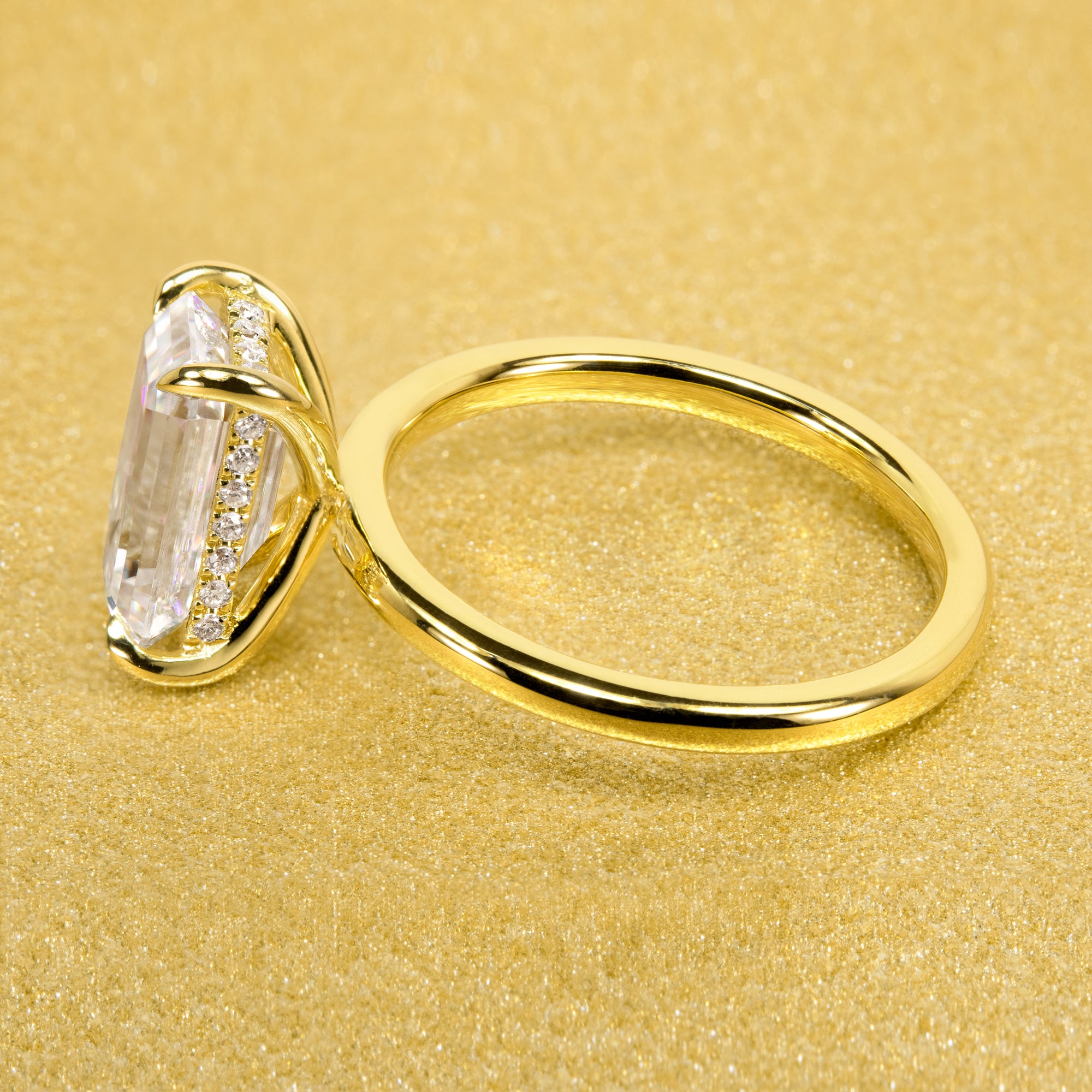 The Adara Elongated 3ct Radiant-cut Moissanite Hidden Halo Engagement Ring is a classic look with an elegant twist complemented by Lab Diamonds handcrafted in 14K Gold, 18K Gold, or Platinum by Earthena Jewelry of Beverly HIlls.