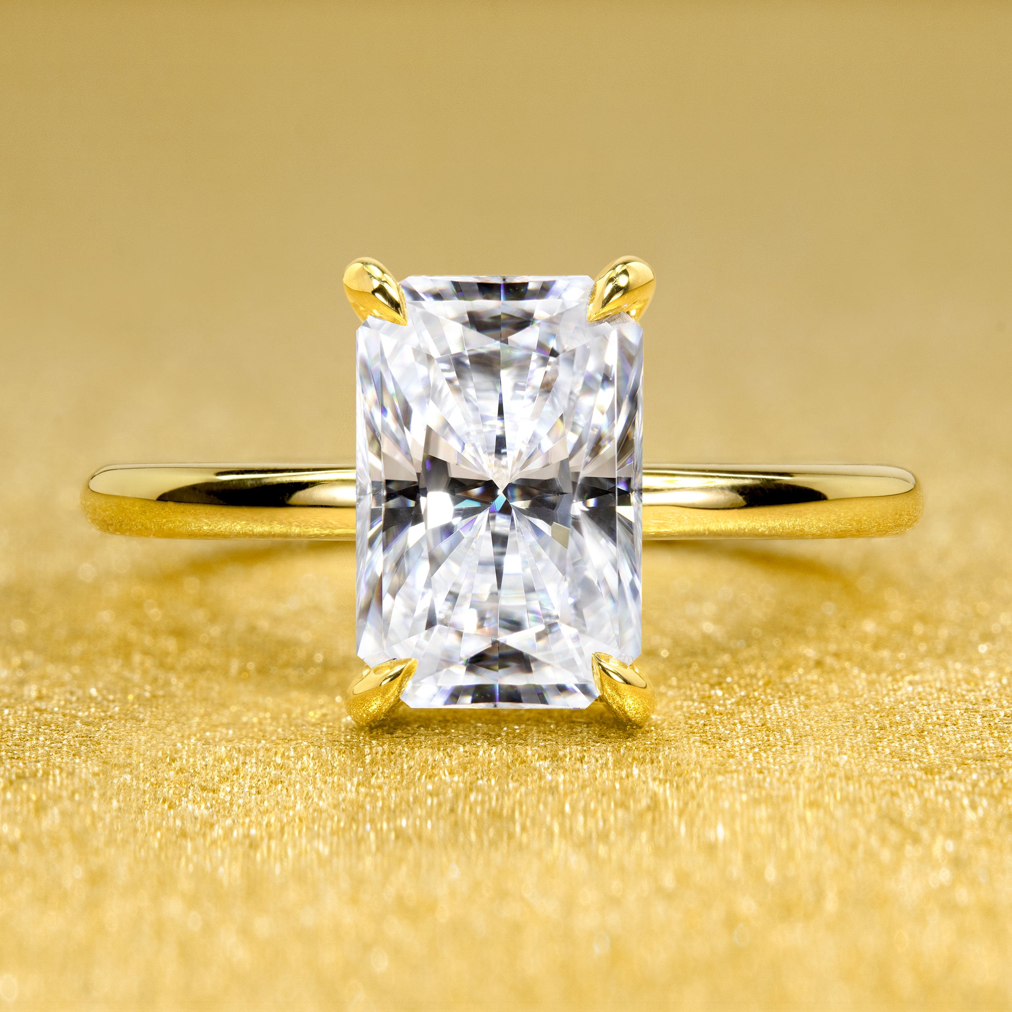 The Adara Elongated 3ct Radiant-cut Moissanite Hidden Halo Engagement Ring is a classic look with an elegant twist complemented by Lab Diamonds handcrafted in 14K Gold, 18K Gold, or Platinum by Earthena Jewelry of Beverly HIlls.