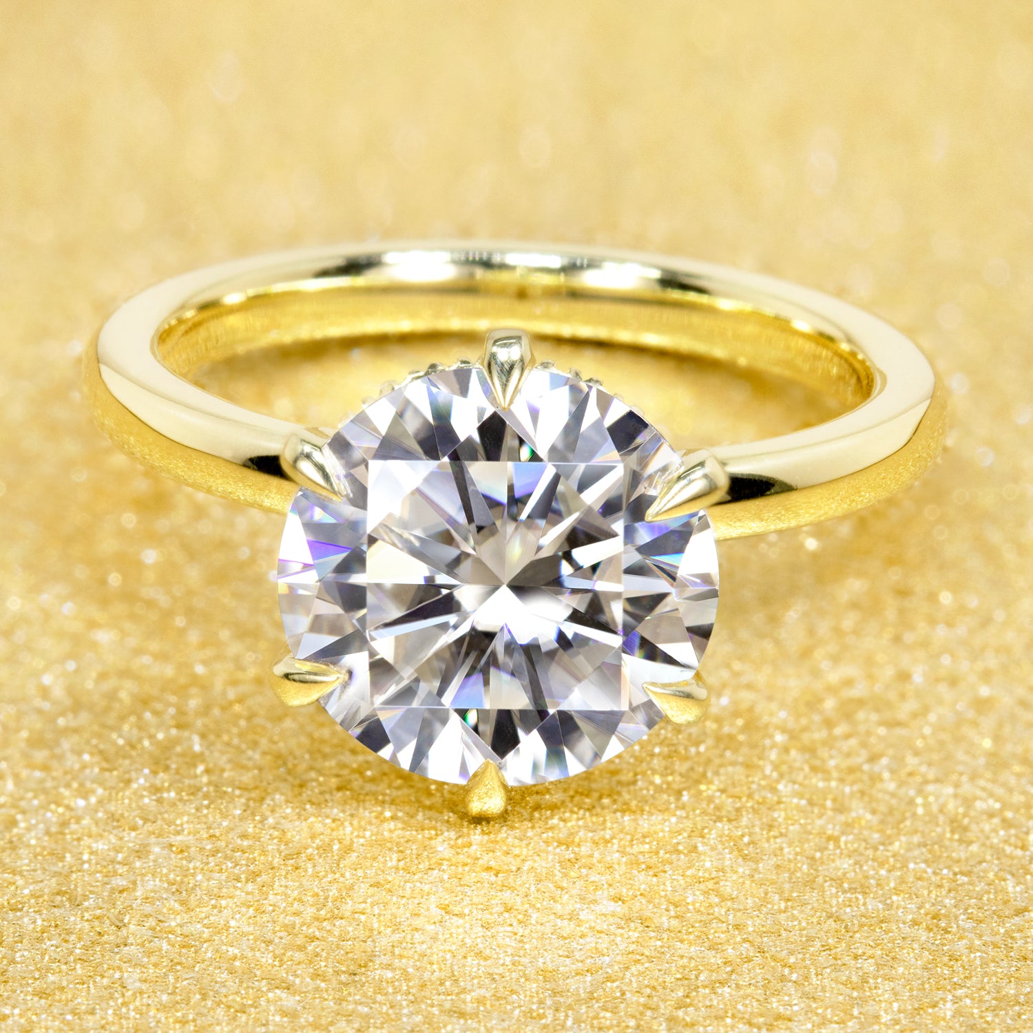 The Adara 3ct Round Brilliant-cut Moissanite Hidden Eternity Halo Engagement Ring is a classic solitaire look with an elegant twist complemented by Lab Diamonds handcrafted in 14K Gold, 18K Gold, or Platinum by Earthena Jewelry of Beverly Hills.