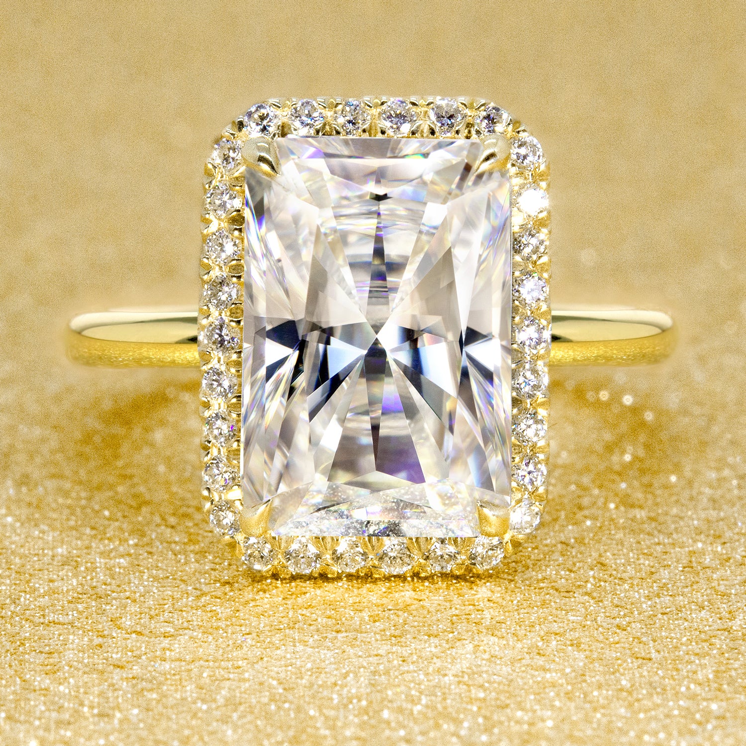 The Adara Elongated Radiant-cut Moissanite Halo Engagement Ring is a classic look with an elegant twist complemented by Lab Diamonds handcrafted in 14K Gold, 18K Gold, or Platinum by Earthena Jewelry of Beverly Hills.
