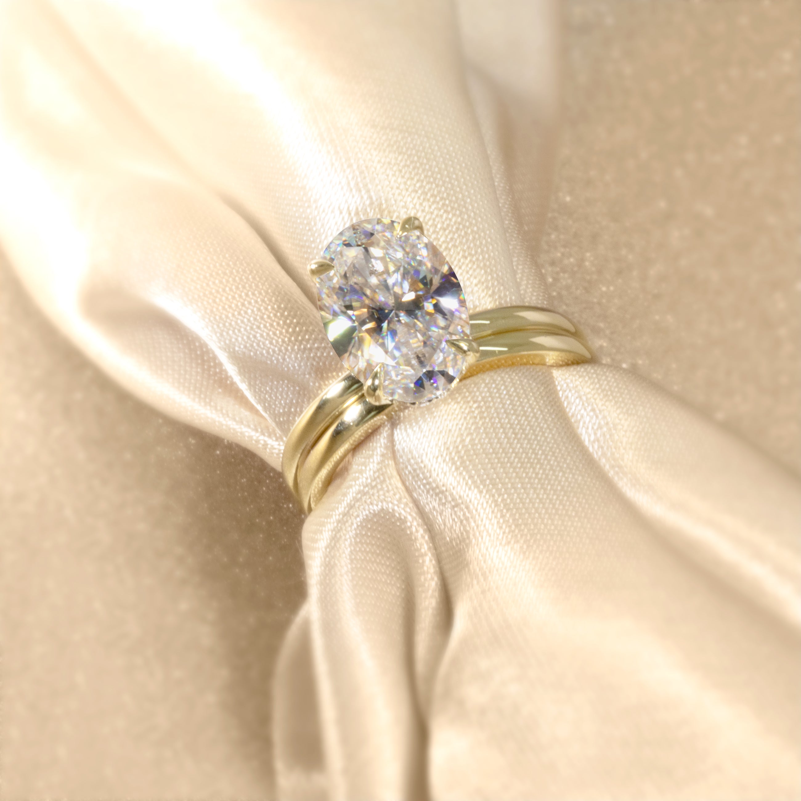 The Adara Elongated Oval-cut Moissanite Hidden Halo Engagement Ring is a classic look with an elegant twist complemented by Lab Diamonds handcrafted in 14K, Gold, 18K Gold, or Platinum by Earthena Jewelry of Beverly Hills.