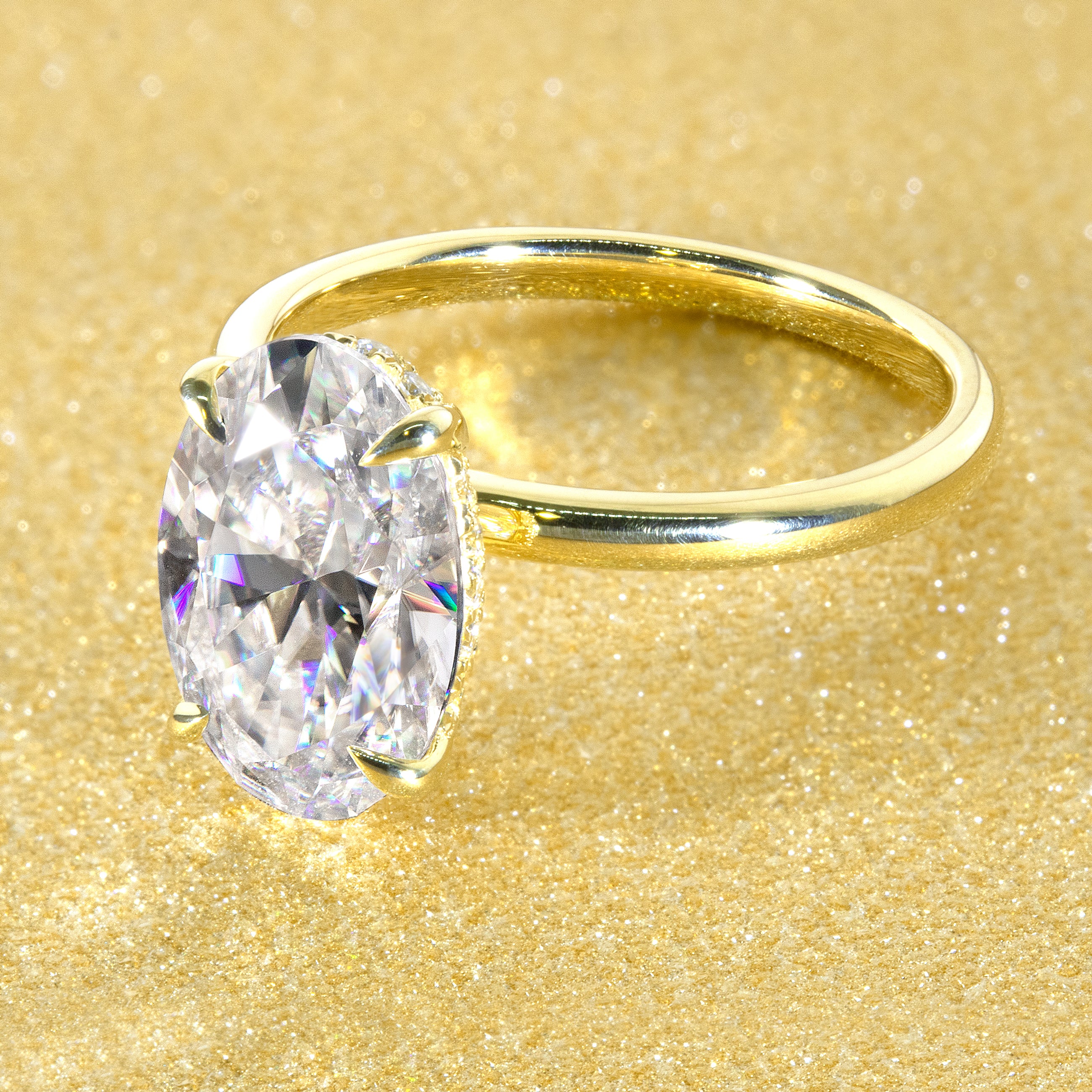 The Adara Elongated Oval-cut Moissanite Hidden Halo Engagement Ring is a classic look with an elegant twist complemented by Lab Diamonds handcrafted in 14K, Gold, 18K Gold, or Platinum by Earthena Jewelry of Beverly Hills.