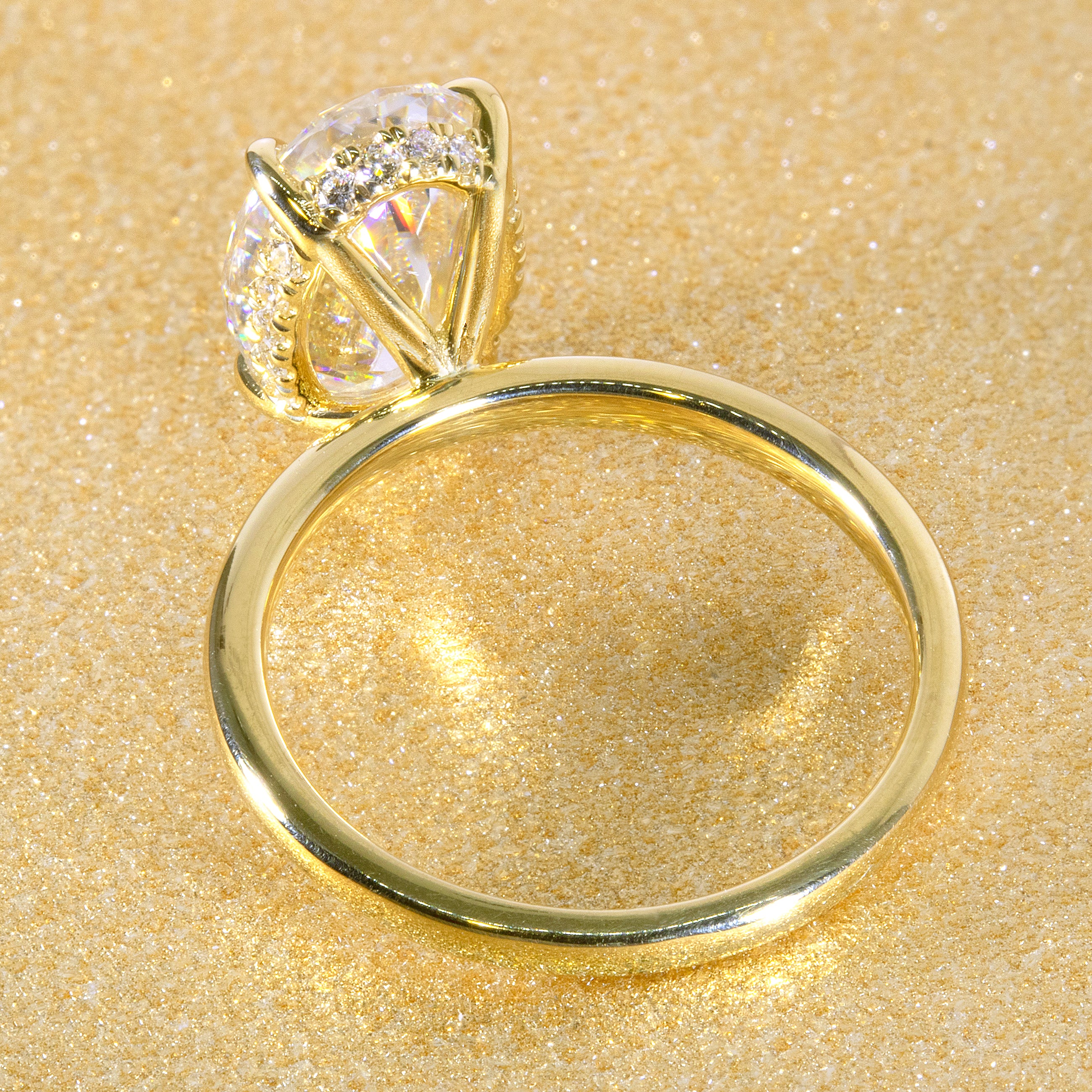 The Adara Elongated Oval-cut Moissanite Hidden Halo Engagement Ring is a classic look with an elegant twist complemented by Lab Diamonds handcrafted in 14K, Gold, 18K Gold, or Platinum by Earthena Jewelry of Beverly Hills.