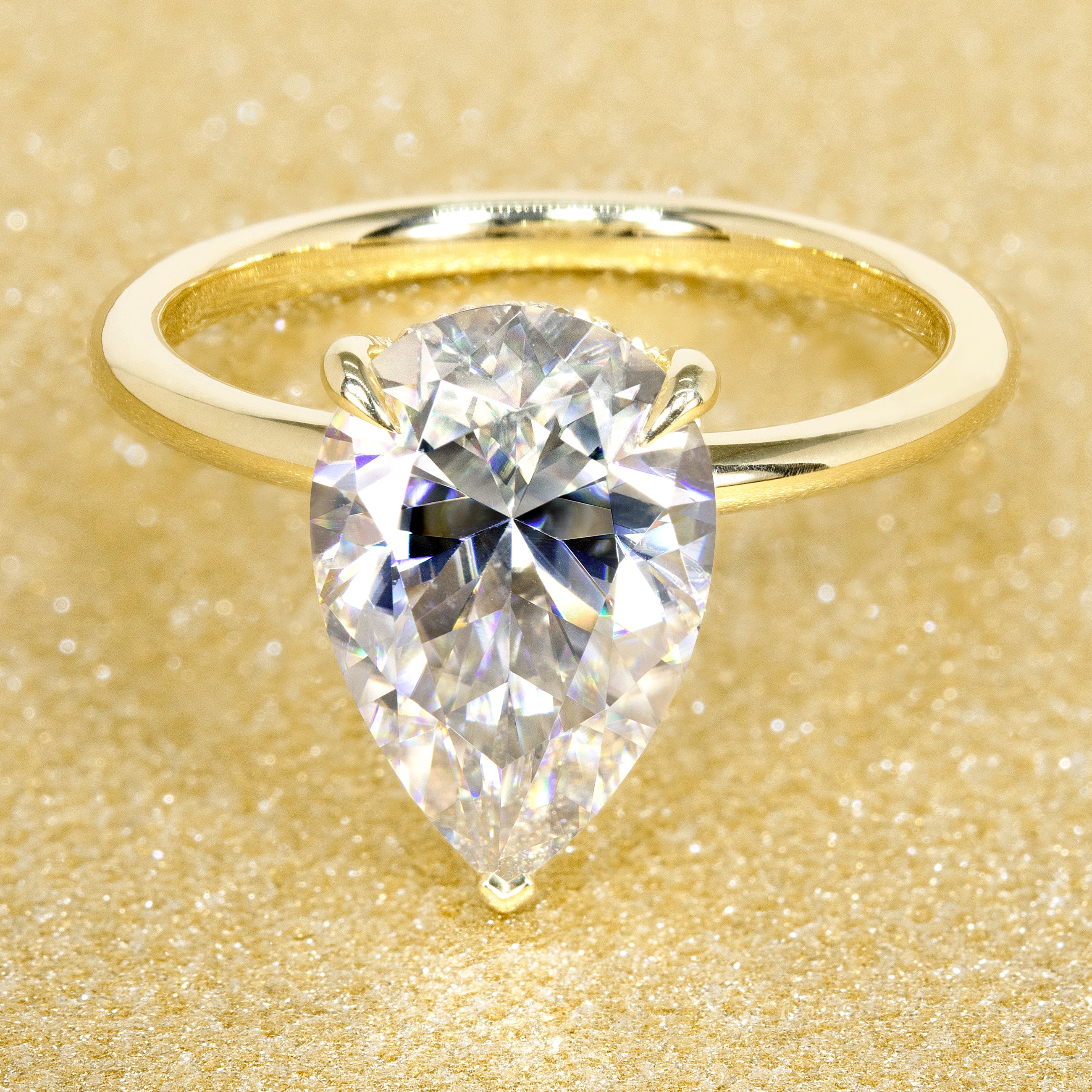 The Adara 3.5ct Pear-shaped Moissanite Hidden Halo Engagement Ring is a classic look with an elegant twist complemented by Lab Diamonds handcrafted in 14K Gold, 18K Gold, or Platinum by Earthena Jewelry of Beverly HIlls