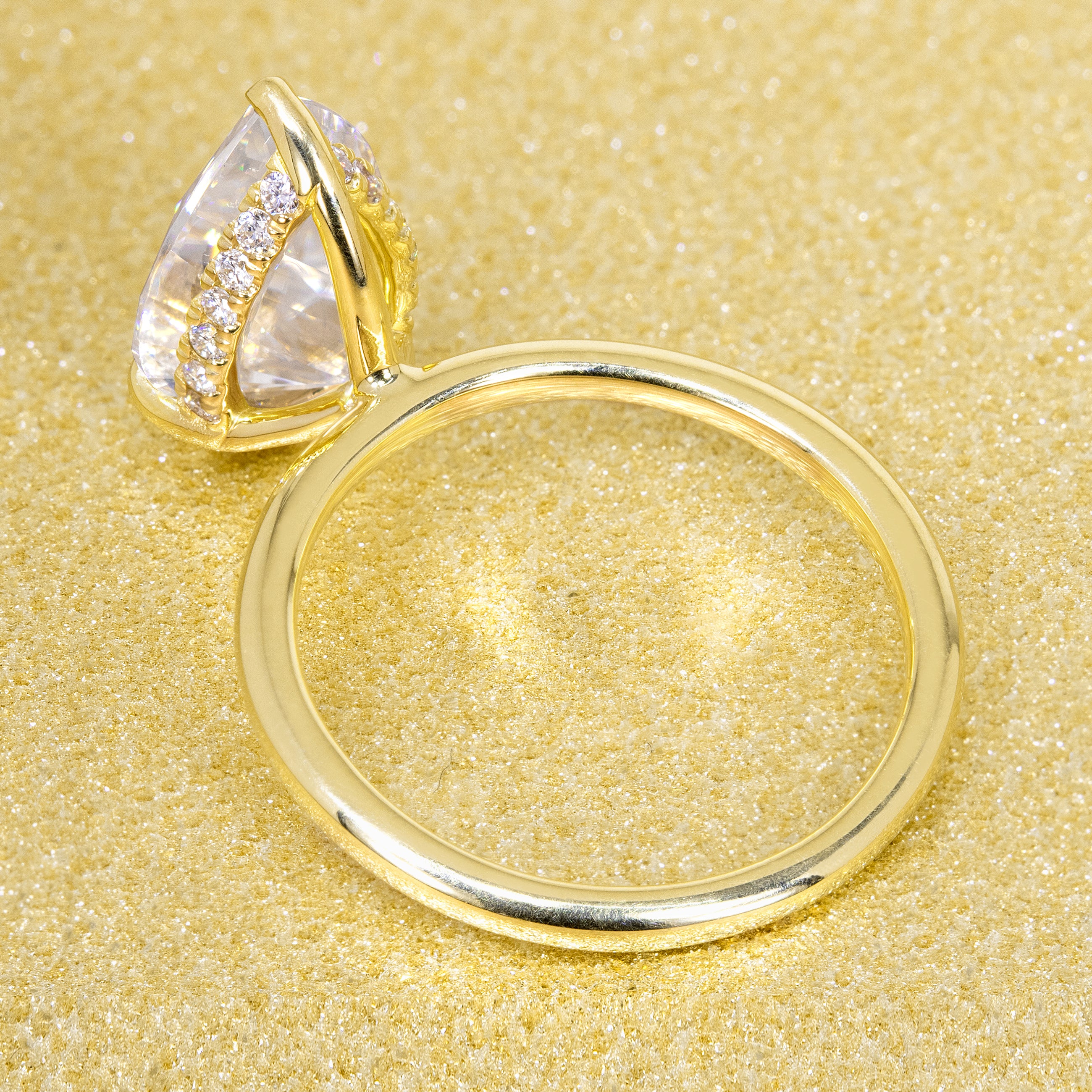 The Adara 3.5ct Pear-shaped Moissanite Hidden Halo Engagement Ring is a classic look with an elegant twist complemented by Lab Diamonds handcrafted in 14K Gold, 18K Gold, or Platinum by Earthena Jewelry of Beverly HIlls