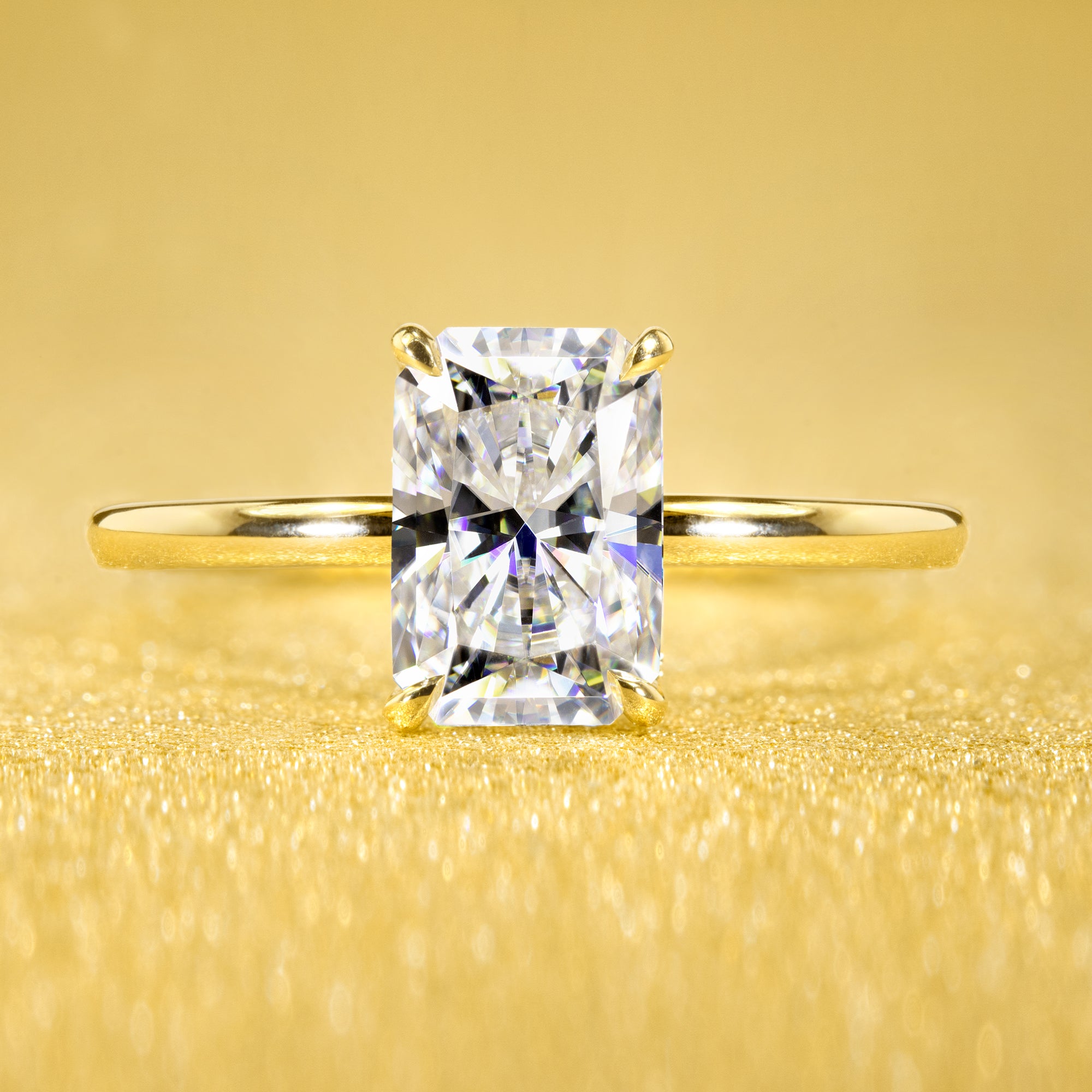 Classic and Minimalistic Ariela 1.5ct Elongated Radiant-cut Moissanite Halo Solitaire Engagement ring complemented by Lab Diamonds handcrafted in 14K Gold, 18K Gold, or Platinum by Earthena Jewelry of Beverly Hills.