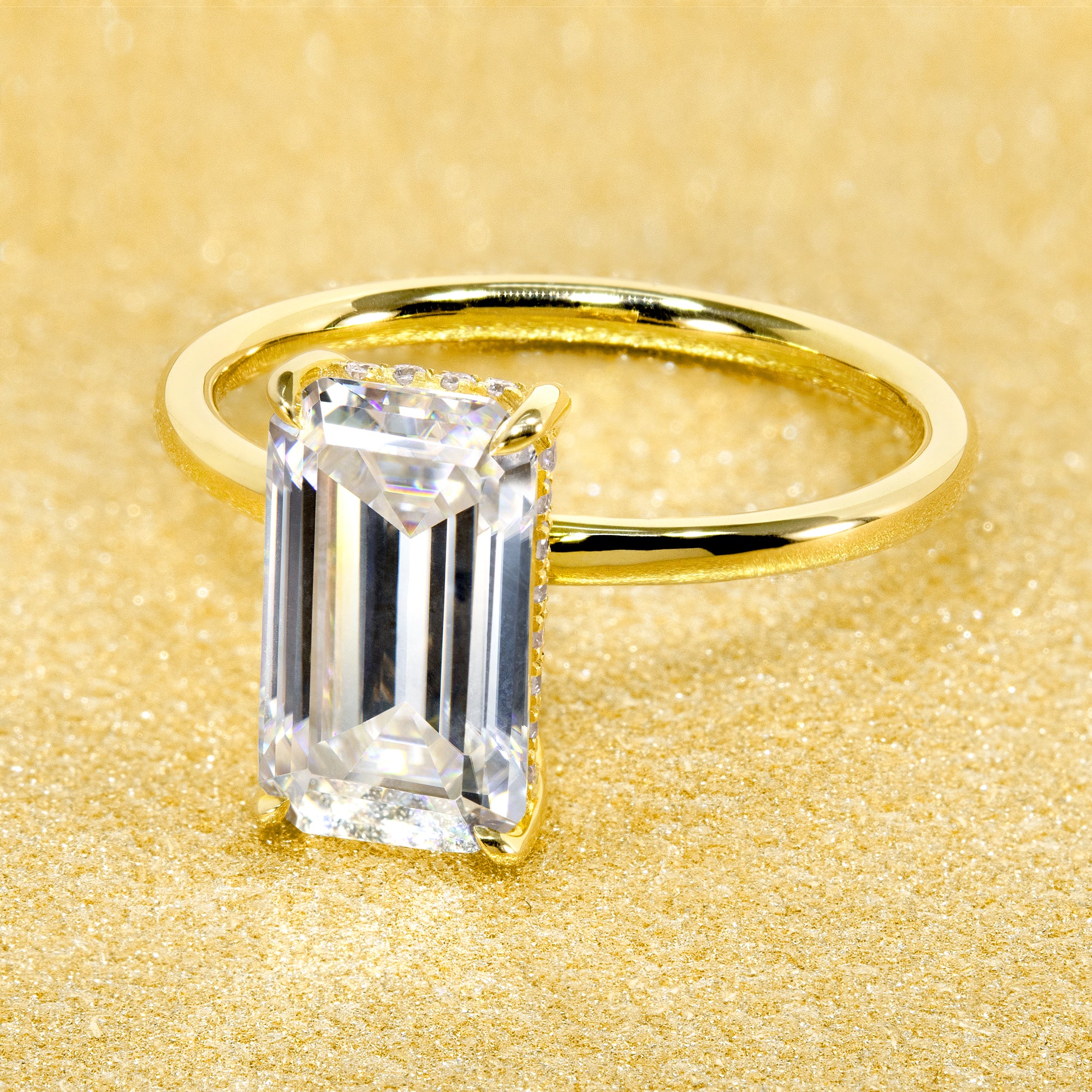 Classic Ariela 3ct Elongated Emerald-cut Moissanite Halo Solitaire Engagement ring complemented by Lab Diamonds handcrafted in 14K Gold, 18K Gold, or Platinum by Earthena Jewelry of Beverly Hills.