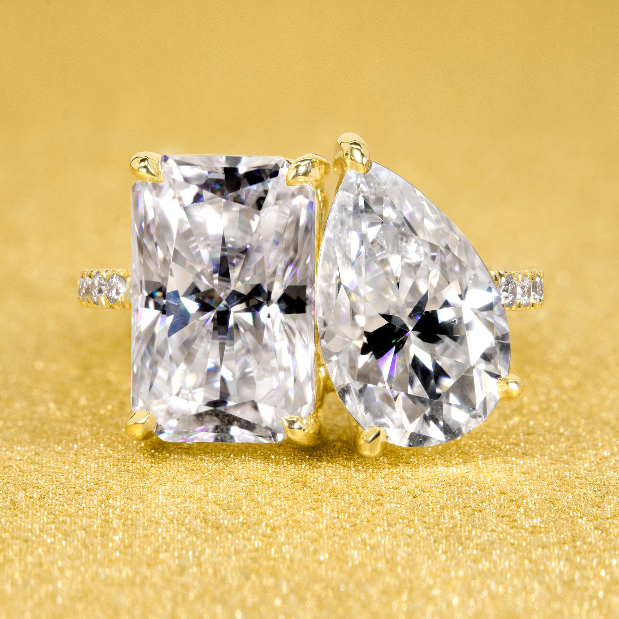 This timeless "Toi et Moi" Gemini engagement ring showcases a captivating combination of a 3.75ct elongated radiant-cut and a 2.25ct pear-shaped moissanite, styled with lab-grown side diamonds. The ring is available in 14K Gold, 18K Gold, or Platinum by Earthena Jewelry of Beverly HIlls.