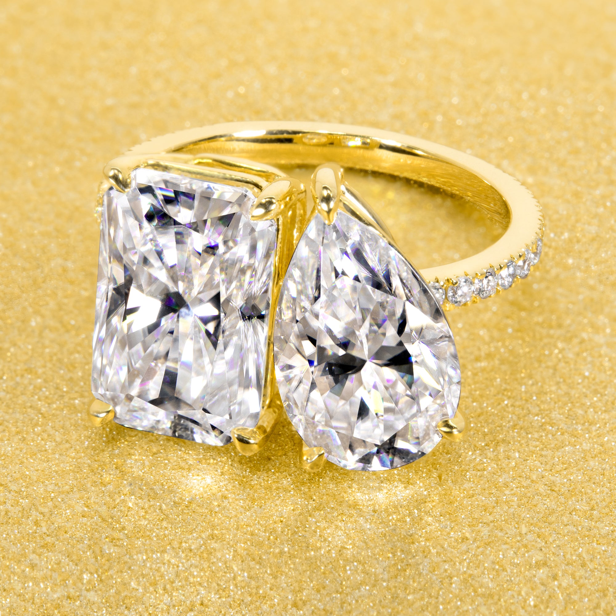 This timeless "Toi et Moi" Gemini engagement ring showcases a captivating combination of a 3.75ct elongated radiant-cut and a 2.25ct pear-shaped moissanite, styled with lab-grown side diamonds. The ring is available in 14K Gold, 18K Gold, or Platinum by Earthena Jewelry of Beverly HIlls.