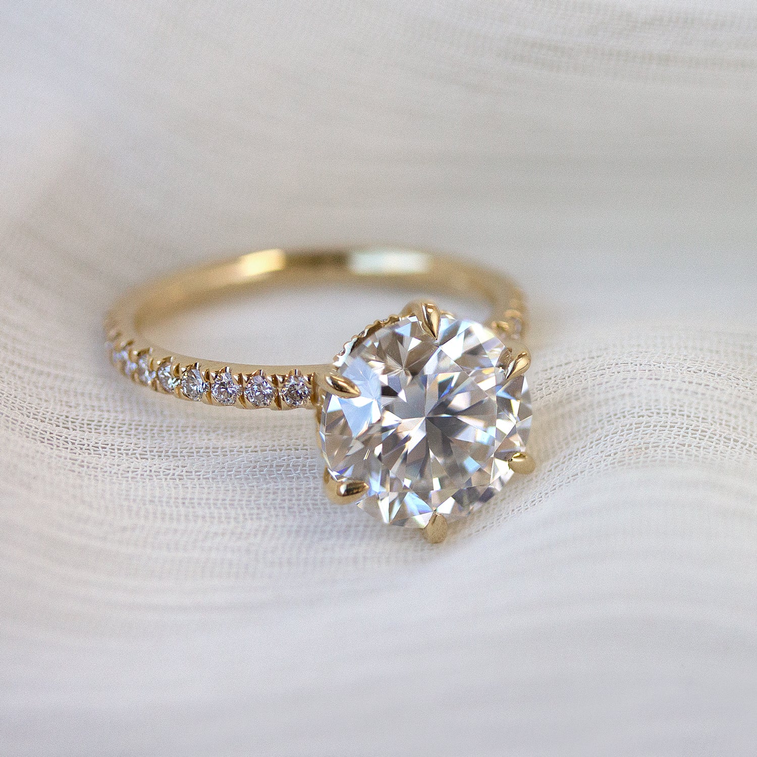 The Selina 3ct Round Brilliant-cut Hidden Eternity Halo Moissanite Engagement Ring, a classic look with an elegant twist complemented by Lab Diamonds handcrafted in 14K gold, 18K gold or Platinum handcrafted in Los Angeles by Earthena Jewelry.