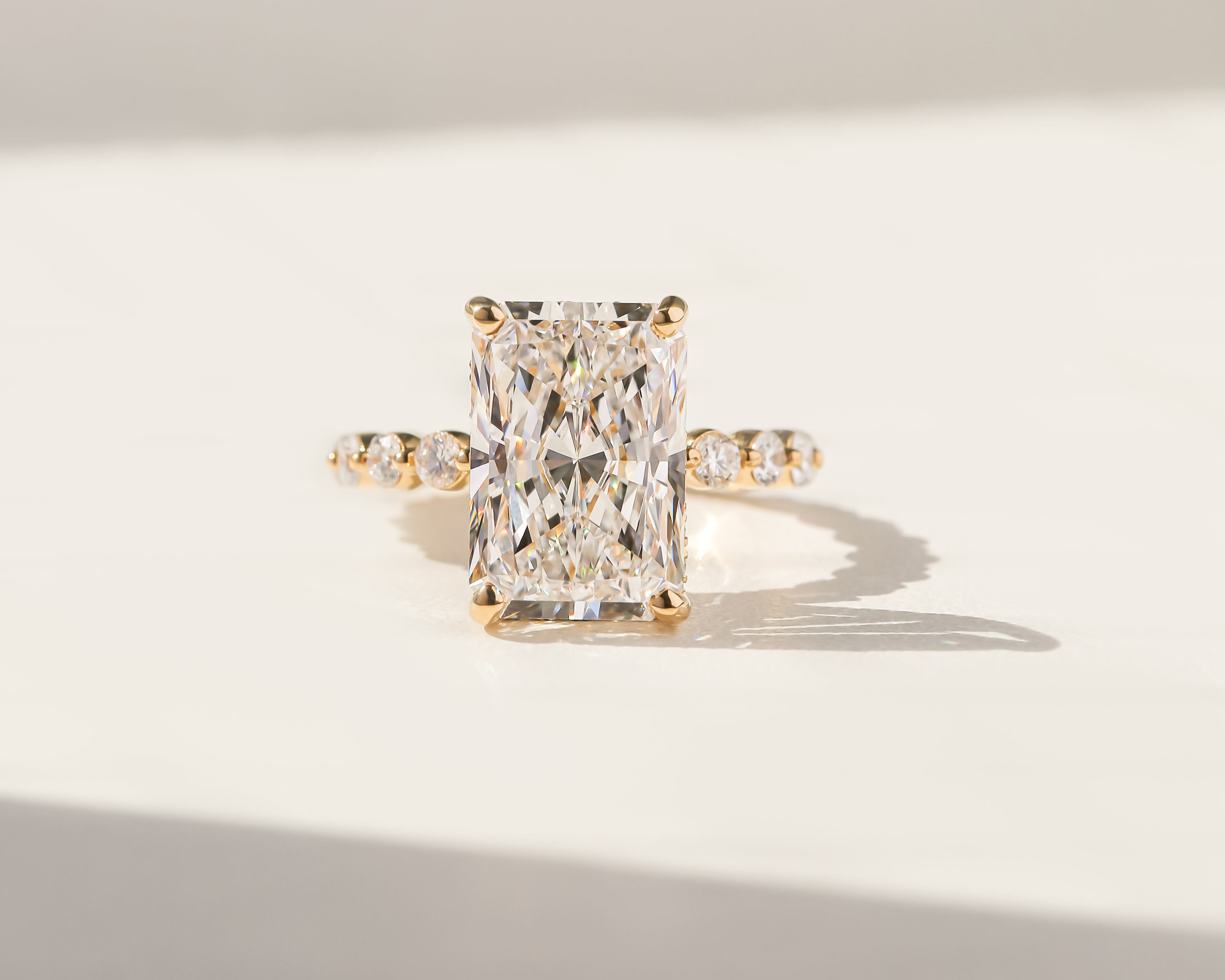 Luna radiant cut hidden halo engagement ring crafted in yellow gold by Earthena Jewelry of Beverly Hills.