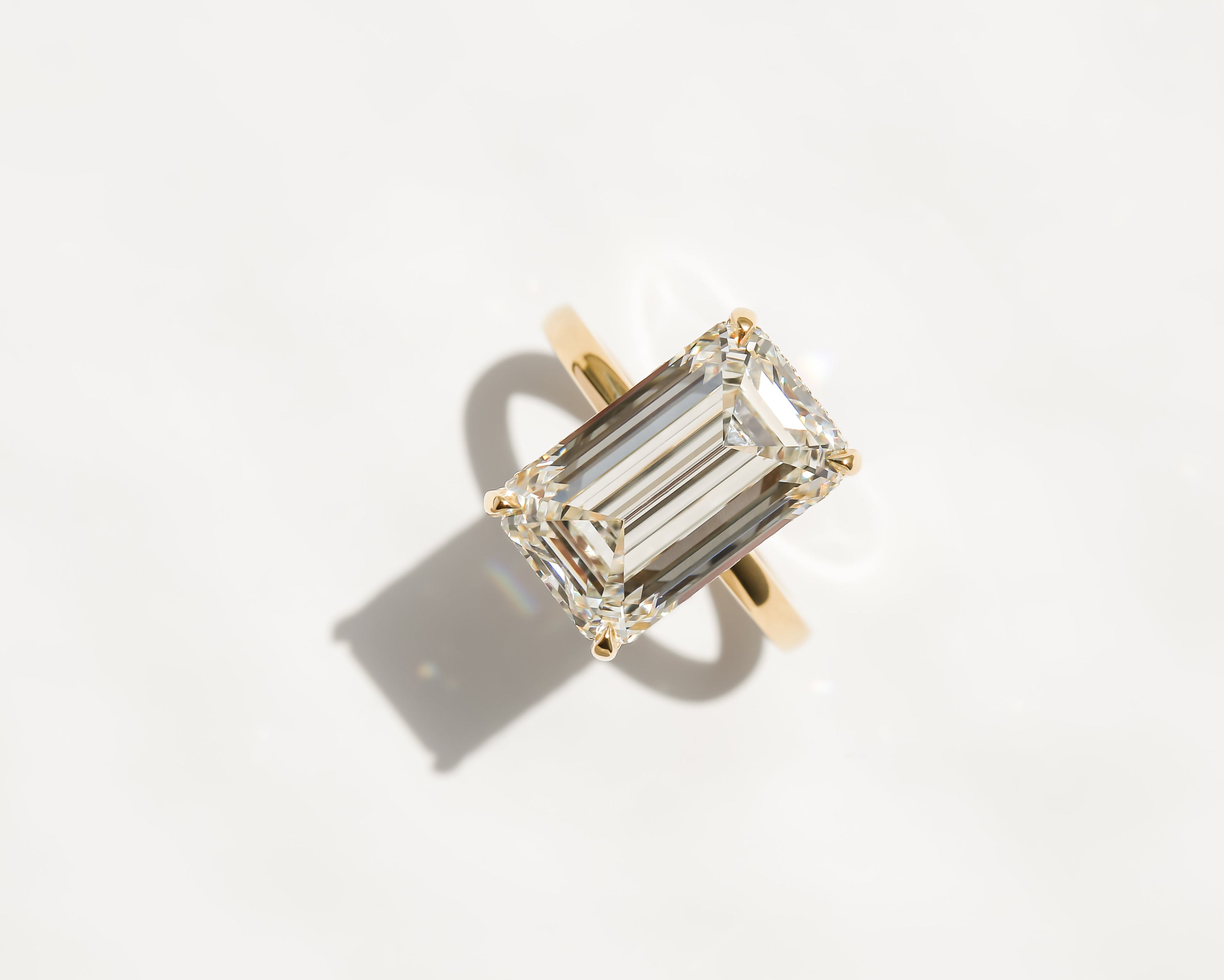 Custom 7ct Emerald-cut hidden halo diamond engagement ring by Earthena Jewelry of Beverly Hills.